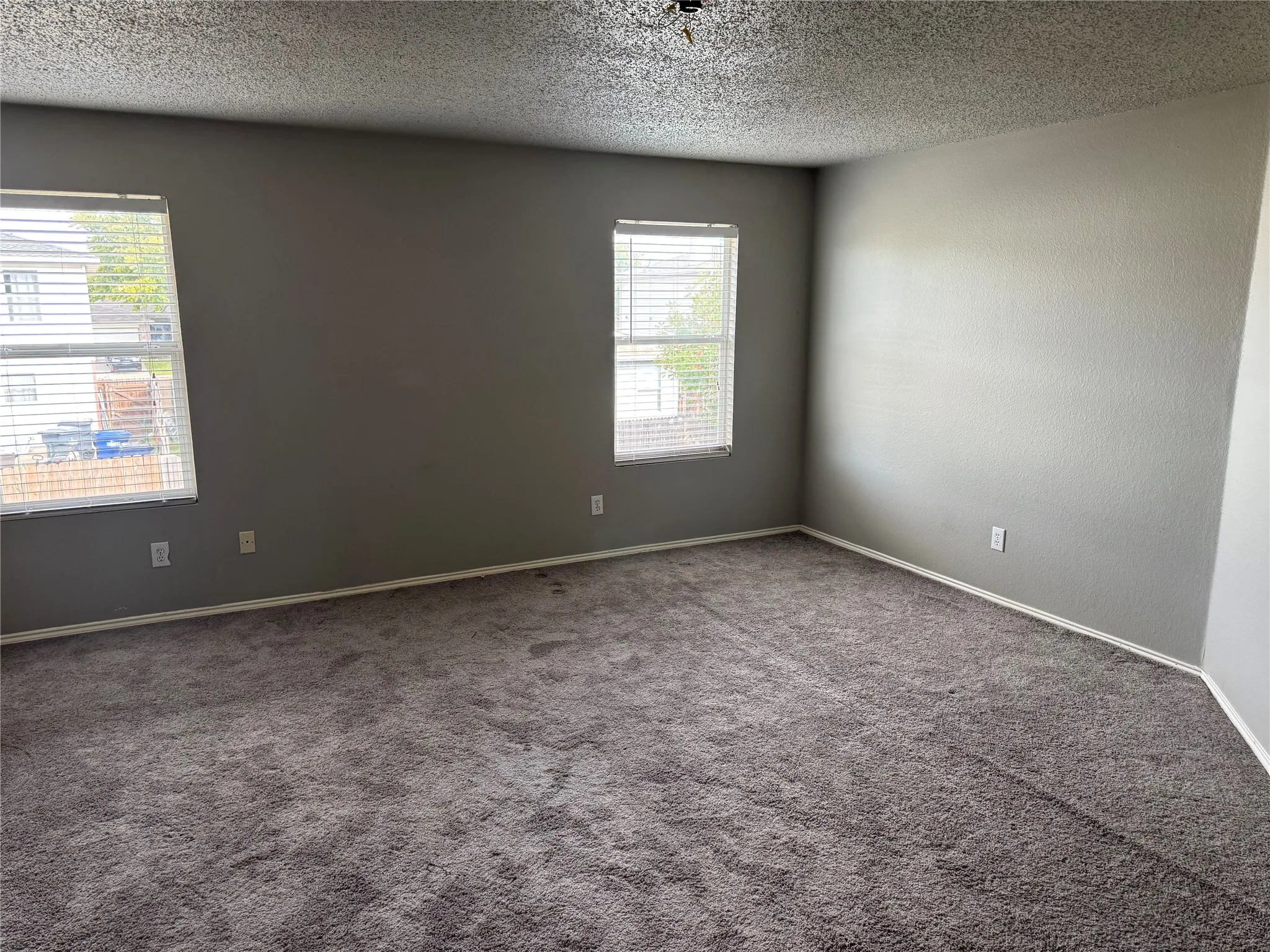 Spare room featuring carpet and a textured ceiling