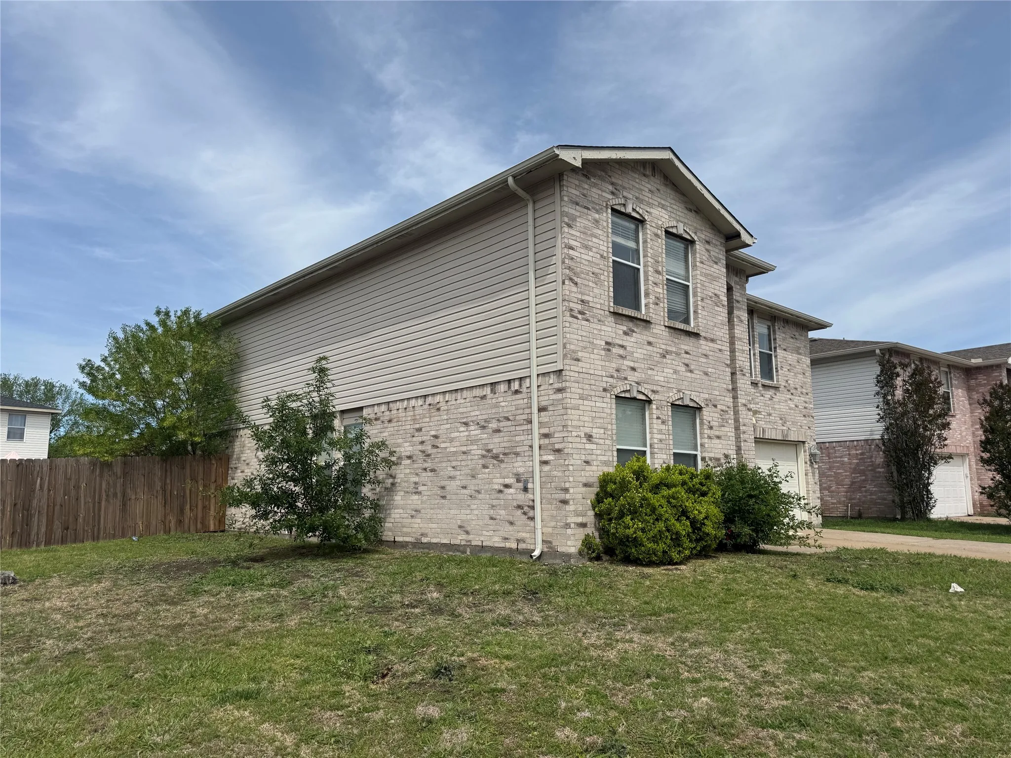 Two-story residence featuring brick and siding exterior construction