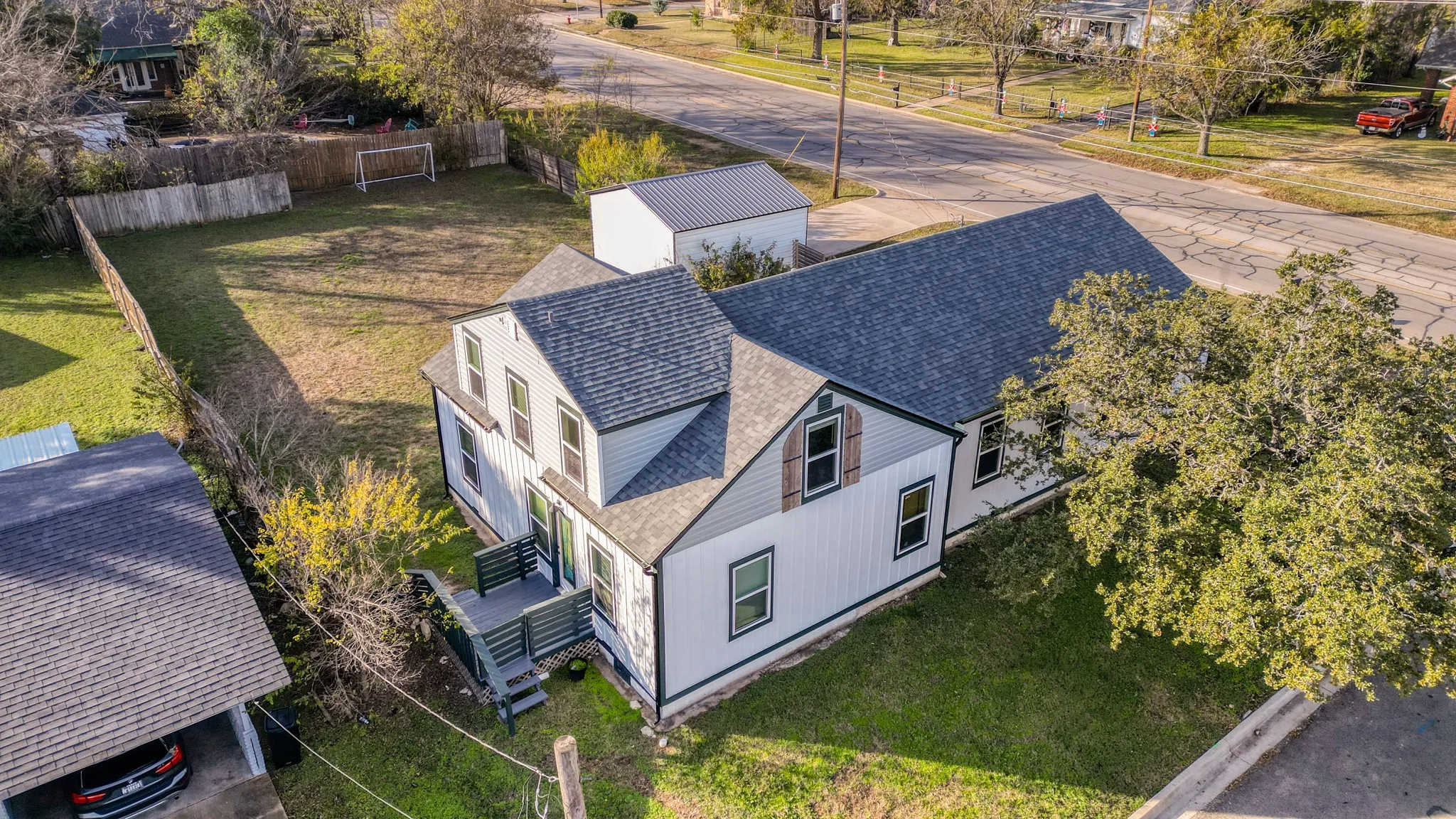 Two-story residence with a gabled roofline and an attached deck