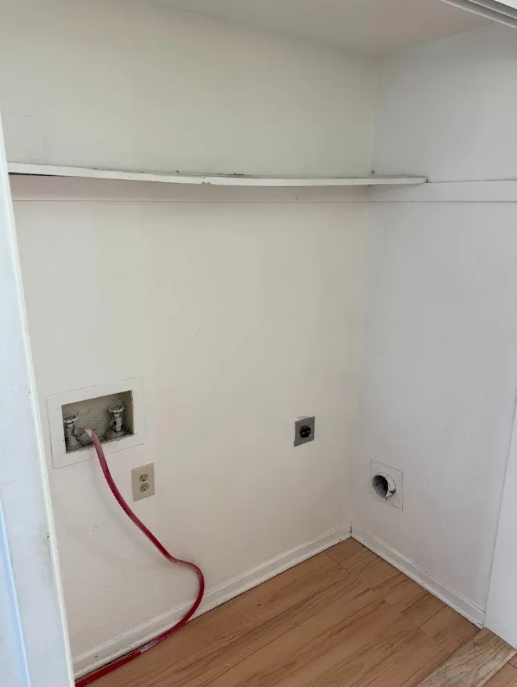Utility area with wood-finish flooring and integrated shelving