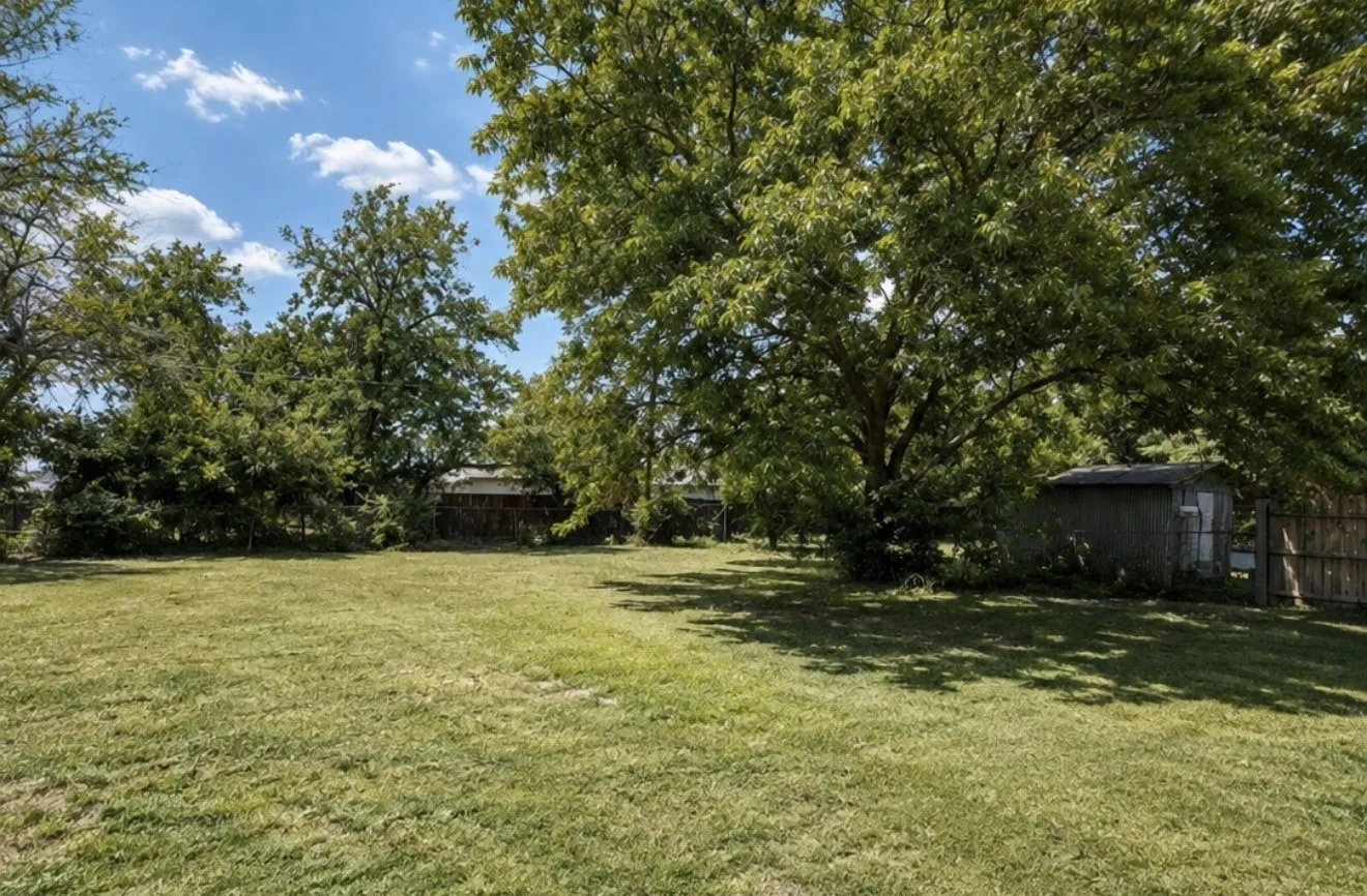 Expansive lot with mature trees and a detached storage shed