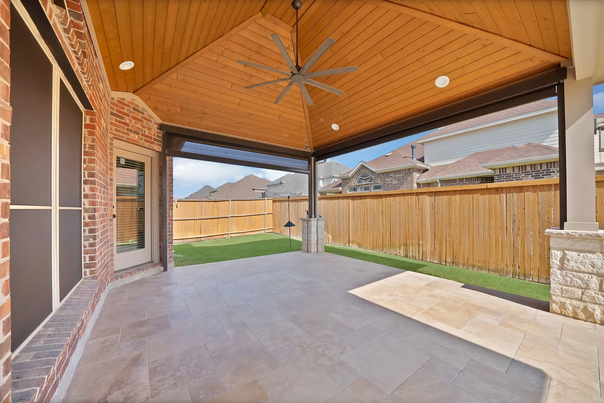 Covered patio featuring a wood-paneled vaulted ceiling, recessed lighting, and a ceiling fan