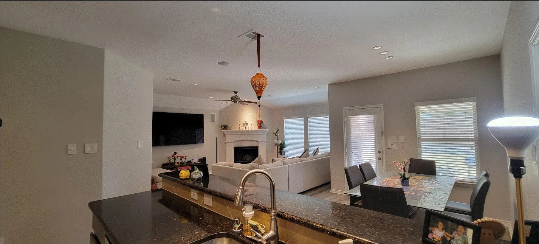 Kitchen island with dark granite-style countertop and undermount sink