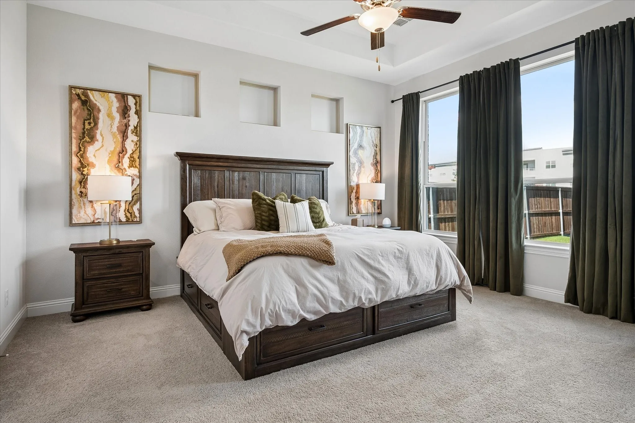 Spacious Master bedroom with ceiling fan and views of the backyard.