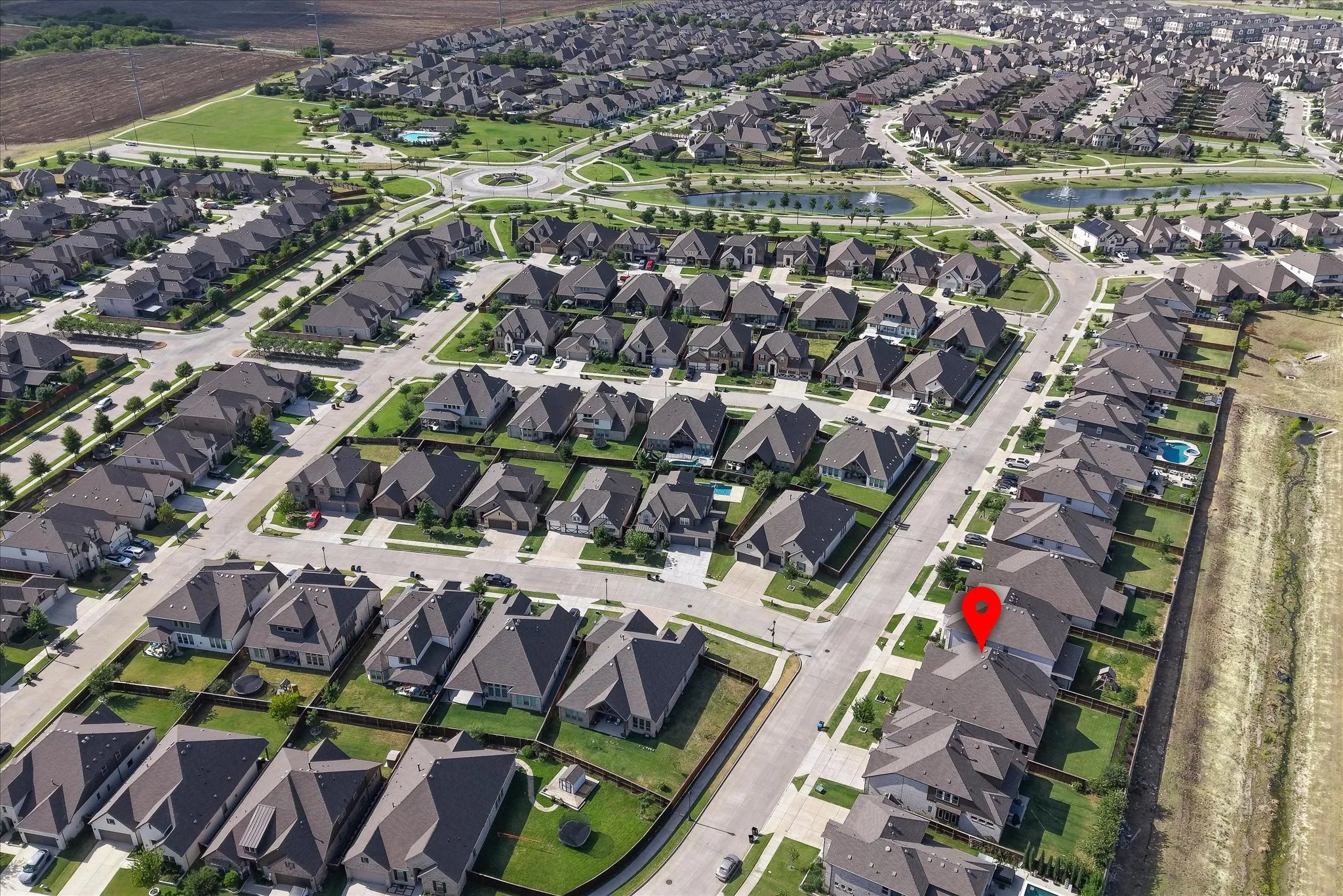 Established residential community featuring two-story homes with distinctive architectural details, manicured lawns, and tree-lined streets.