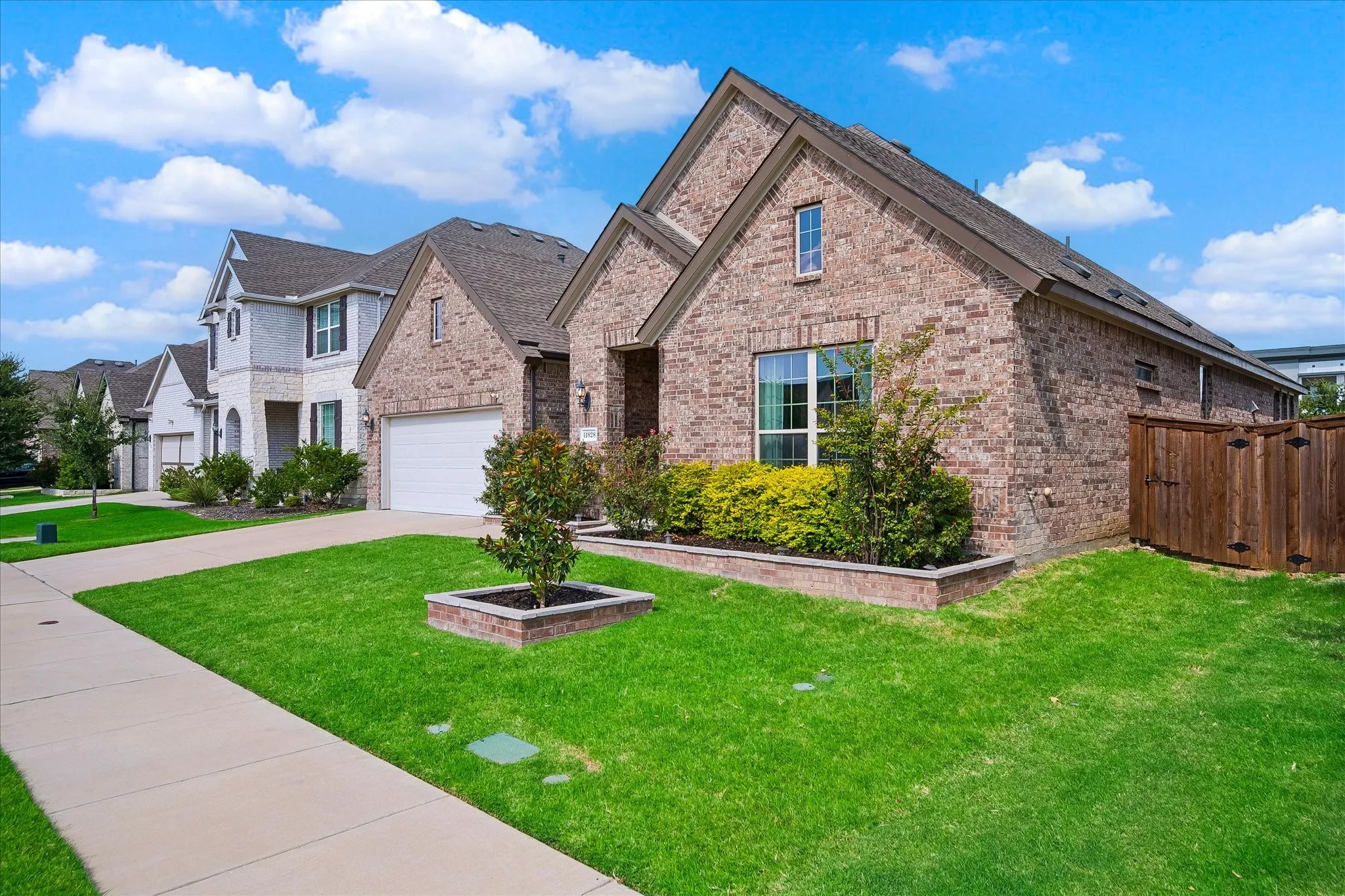 Brick exterior with a gabled roof and an attached garage