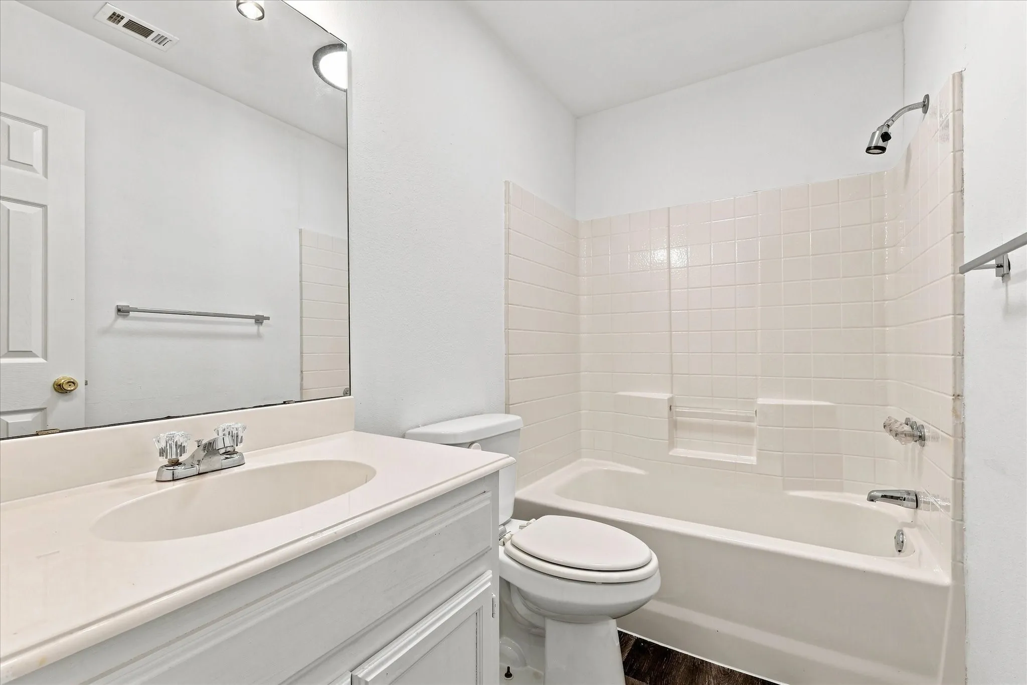 Bathroom featuring a built-in vanity with an integrated sink, polished chrome faucet, and a large wall-mounted mirror