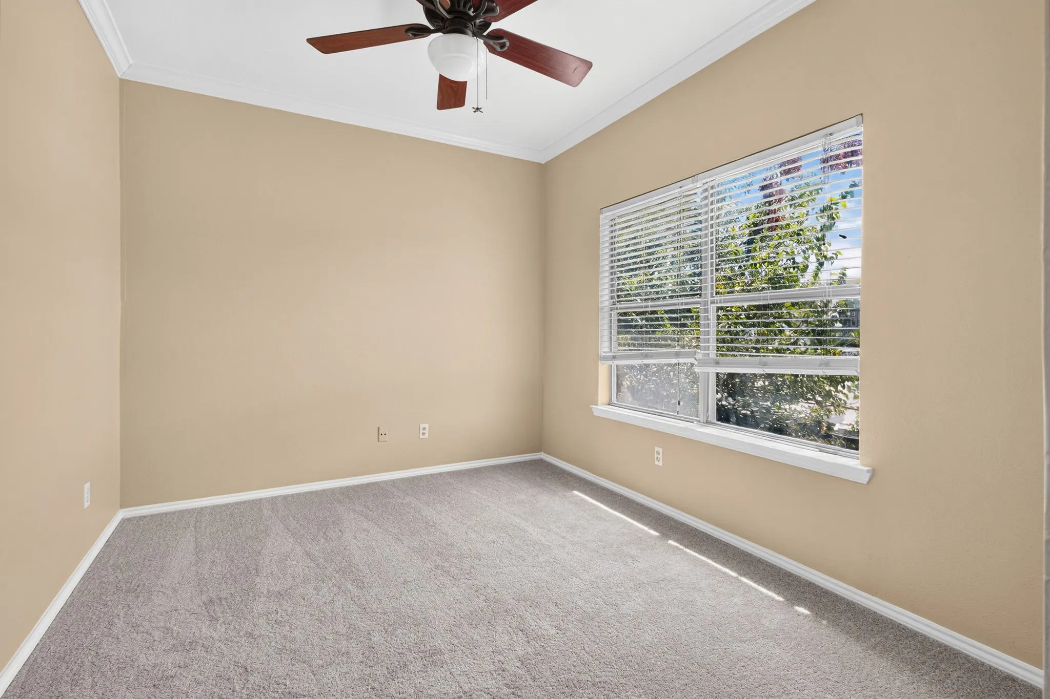 Recessed window with white blinds, crown molding, ceiling fan with integrated lighting, and neutral wall tones