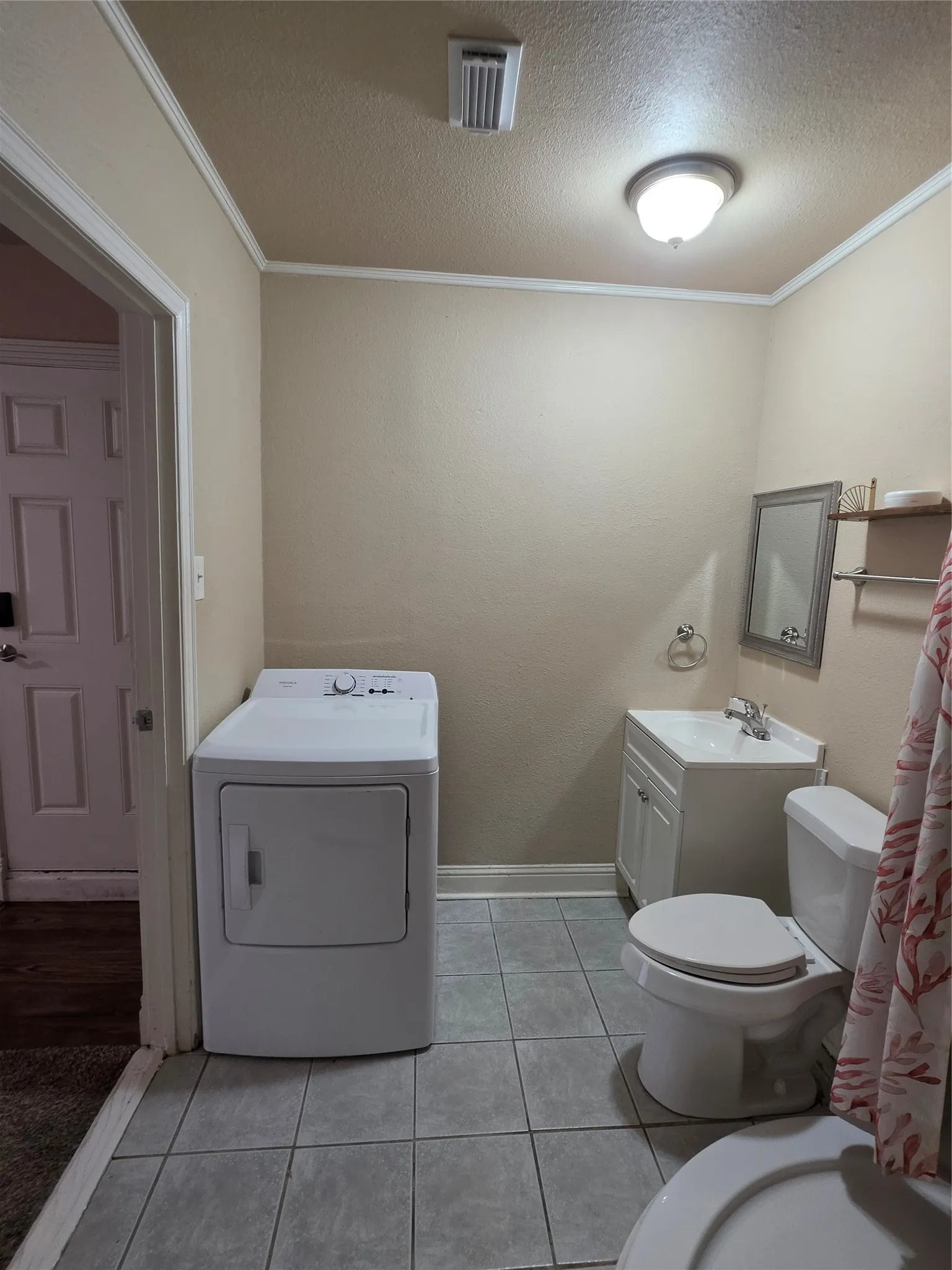 Tile flooring with a single vanity, mirror, and toilet