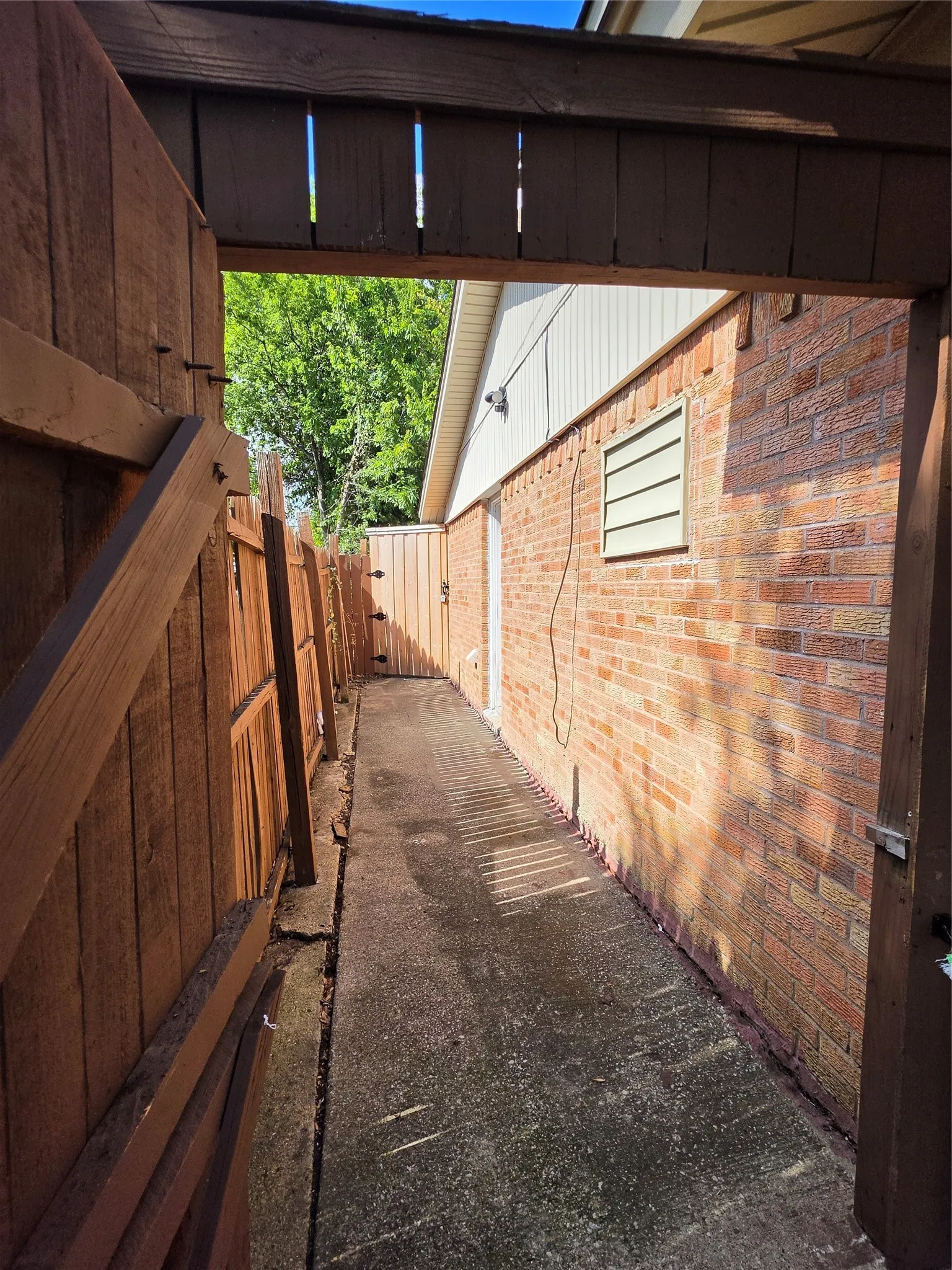Privacy fencing with wood construction, brick exterior, concrete walkway