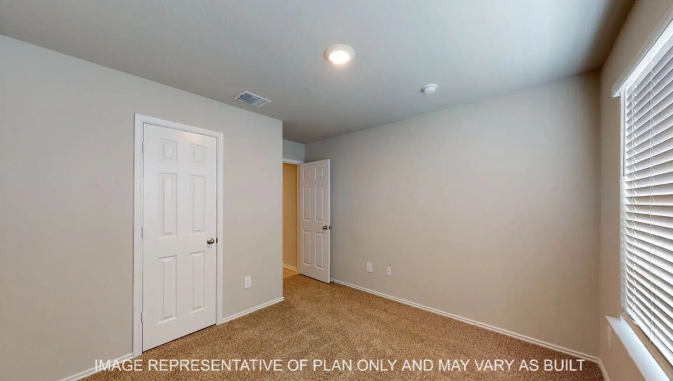 Spacious secondary bedroom with neutral wall finishes, recessed ceiling lighting, and abundant natural light from dual windows