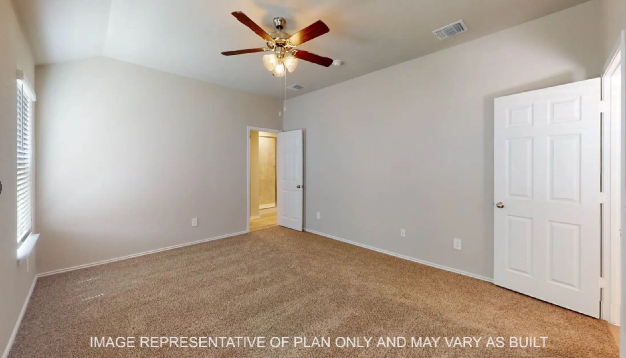Spacious bedroom with neutral wall finishes, wood-finish flooring, ceiling fan with integrated lighting, and dual closet access via six-panel doors