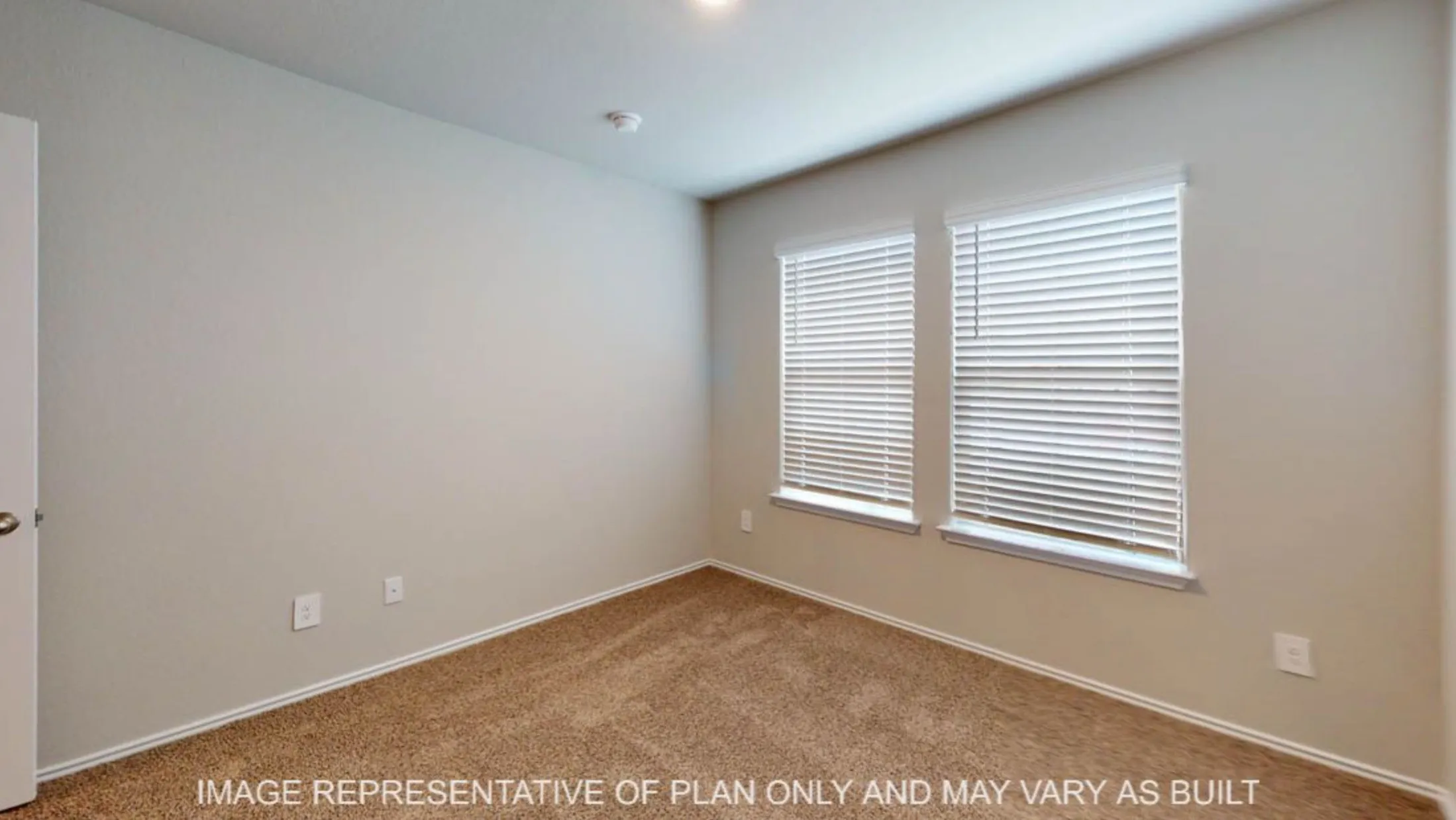 Neutral-toned walls, carpeted flooring, and two windows with blinds