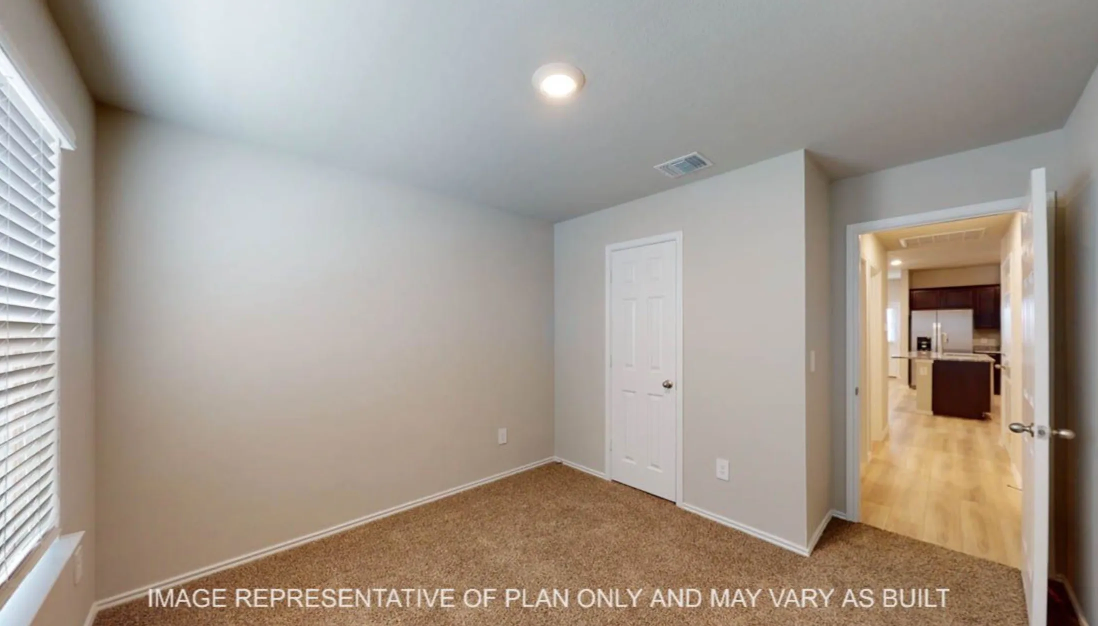Carpeted room with recessed lighting and a window with blinds