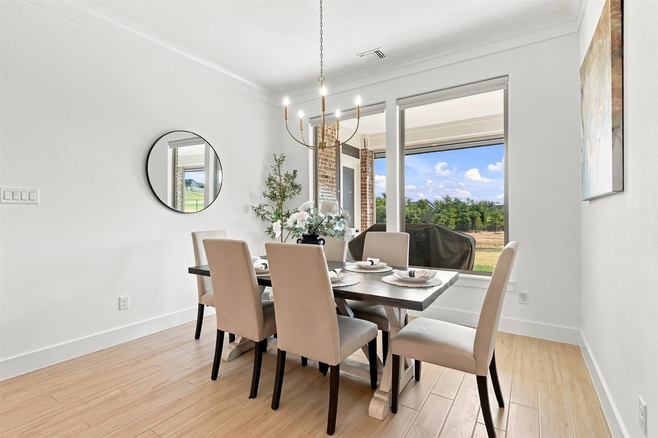 Recessed lighting, wood-finish flooring, crown molding, and large windows