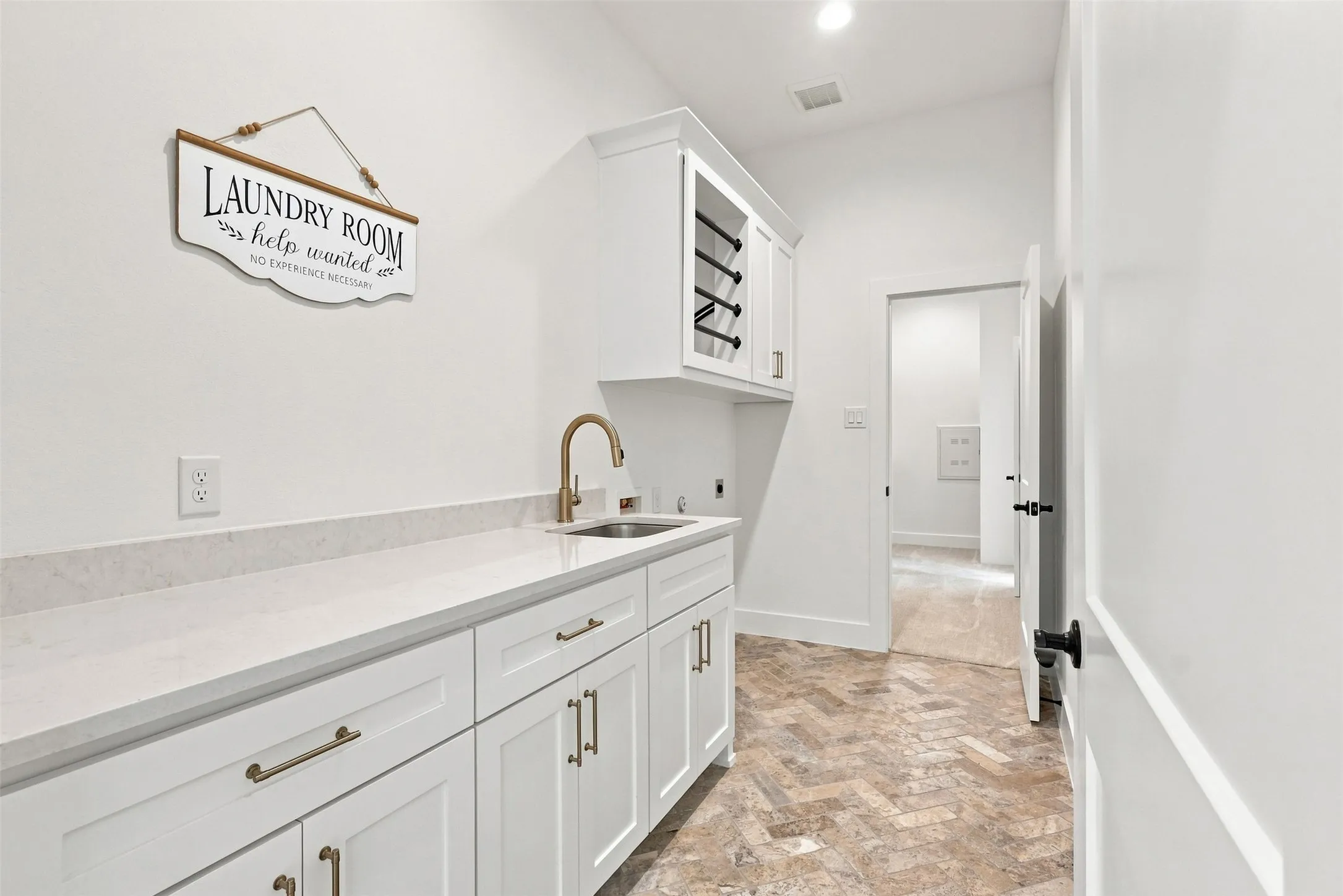 Utility / Laundry Room with sink and built in cabinets including a clothes drying rack.