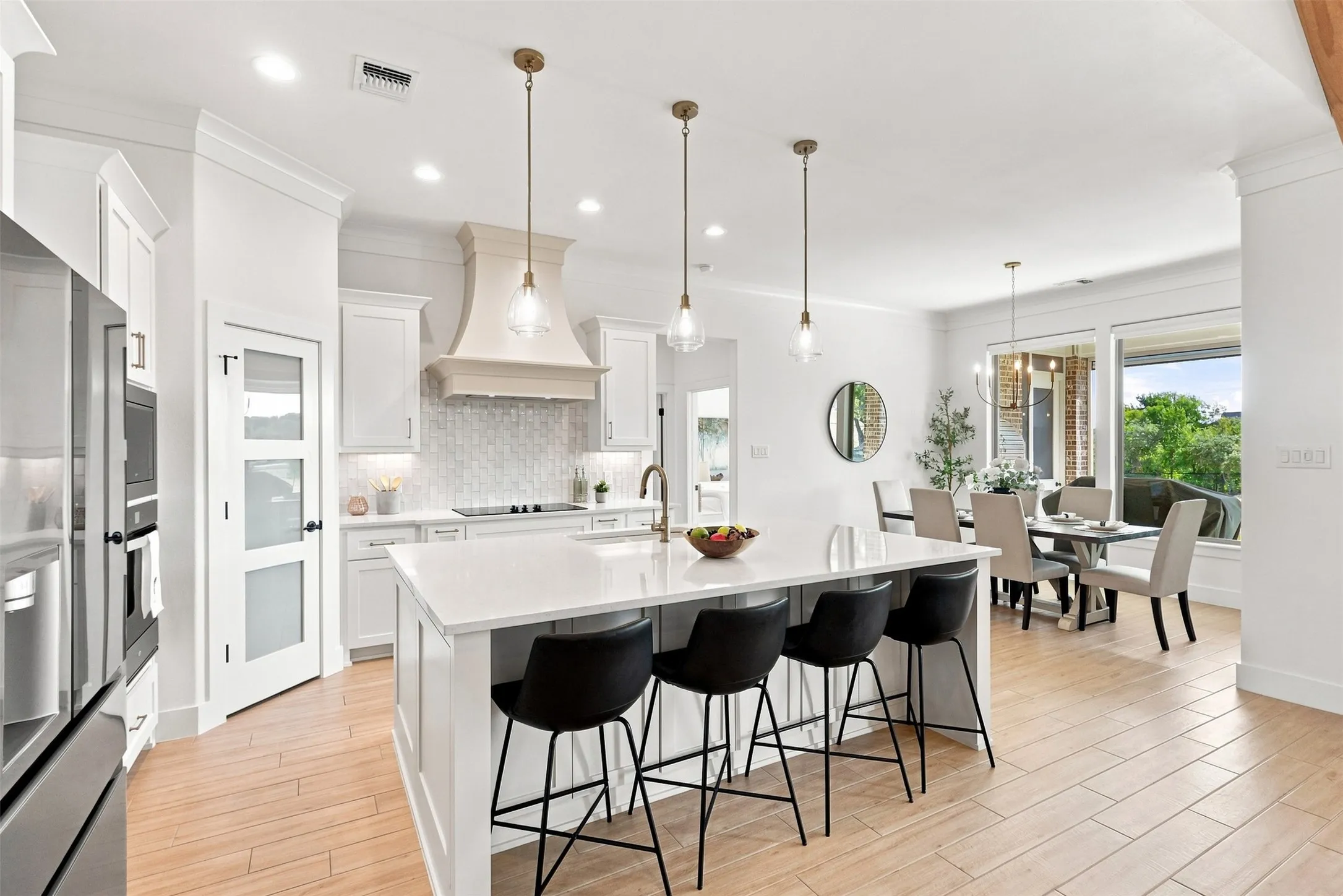 Expansive kitchen island with a white countertop and pendant lighting