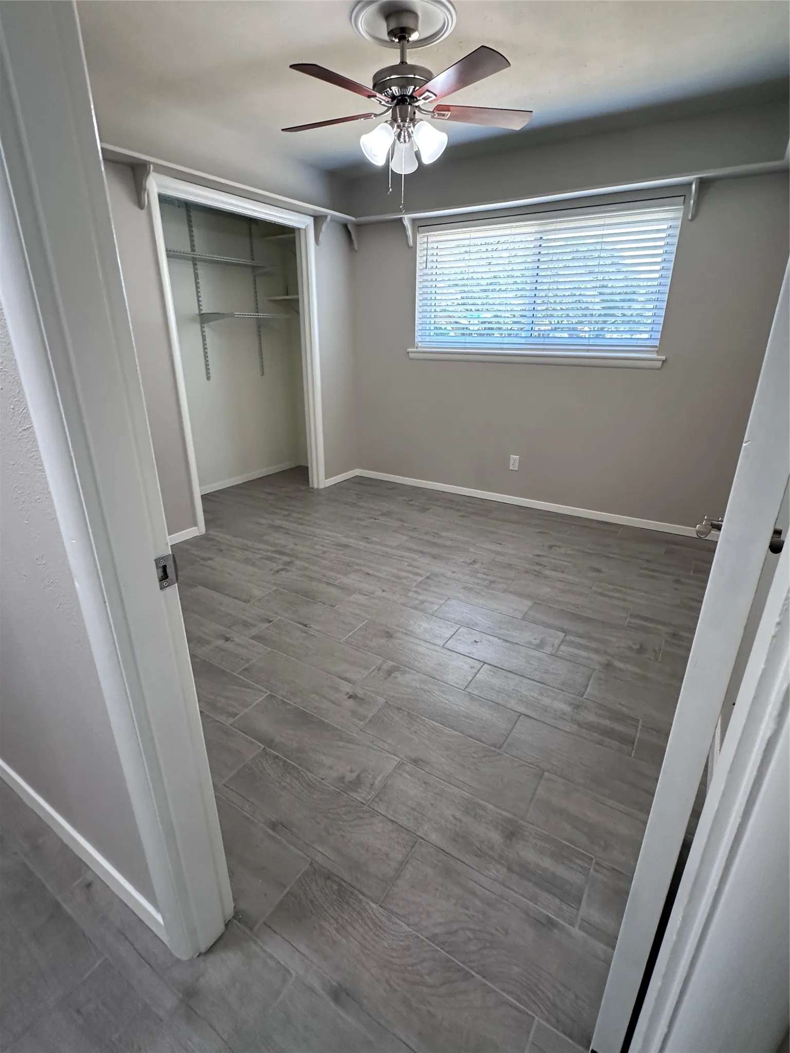 Neutral tone wall finish with wood-look tile flooring