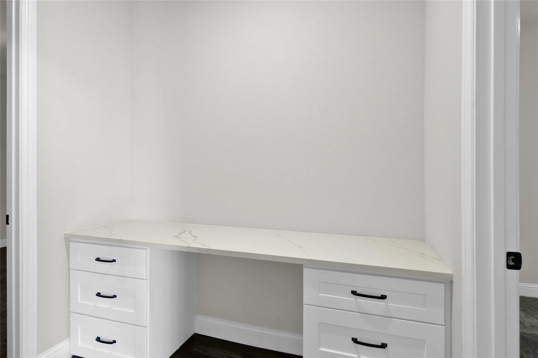 Desk area separating 2 of the secondary bedrooms that share a full.