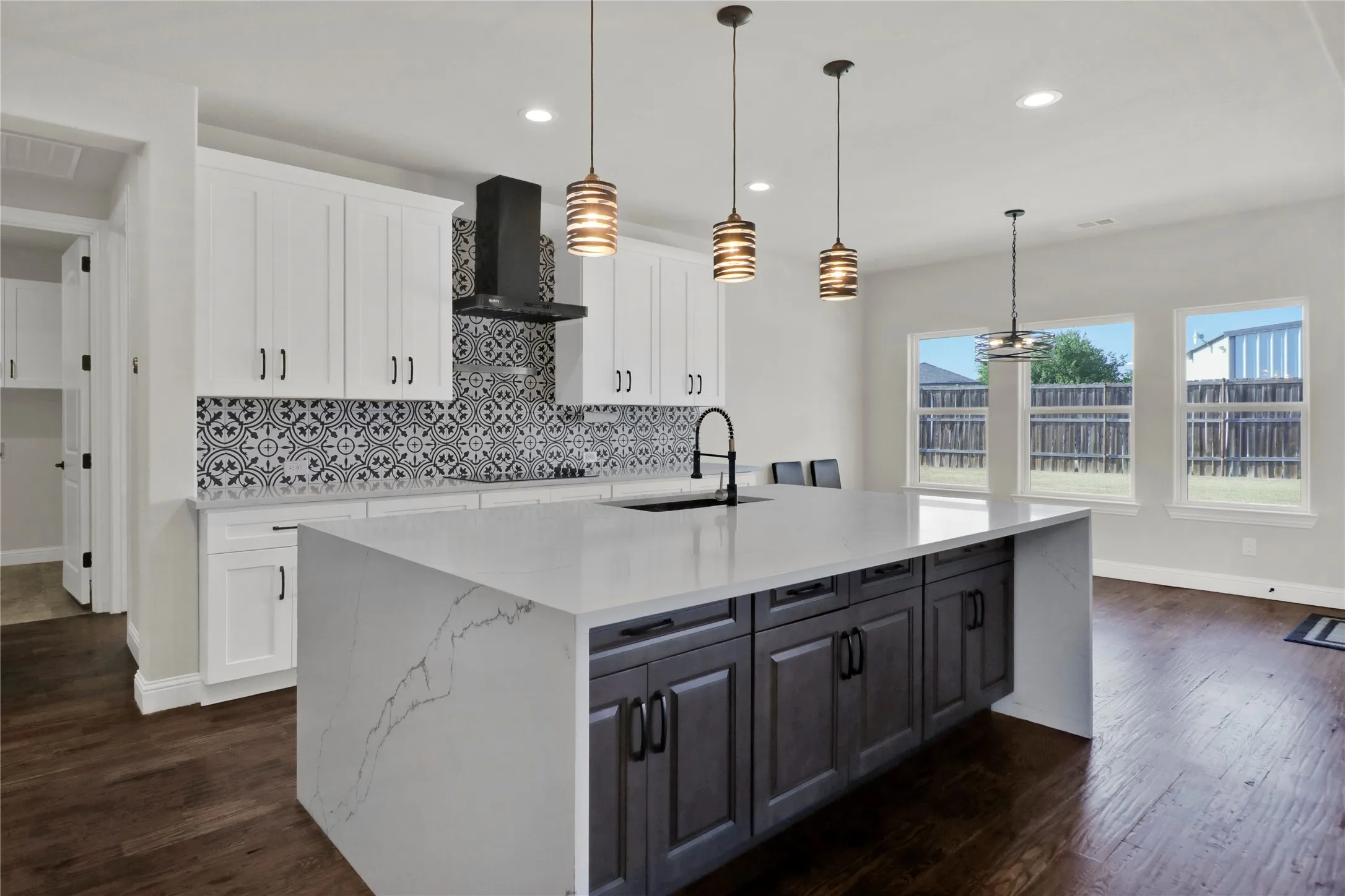 Even breakfast bar, stunning counters and backsplash.