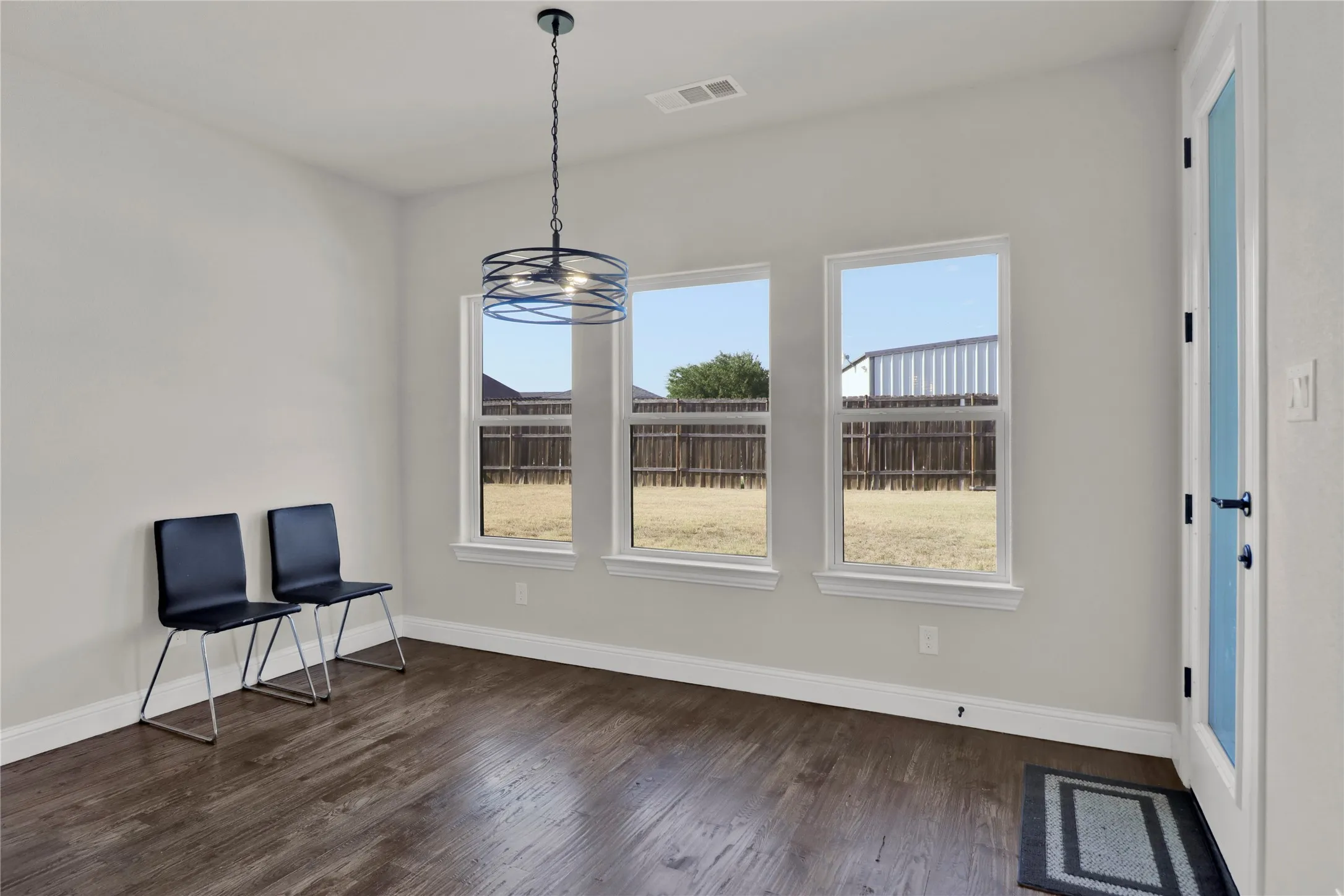 Dining overlooks the back yard for easy access for grilling food.