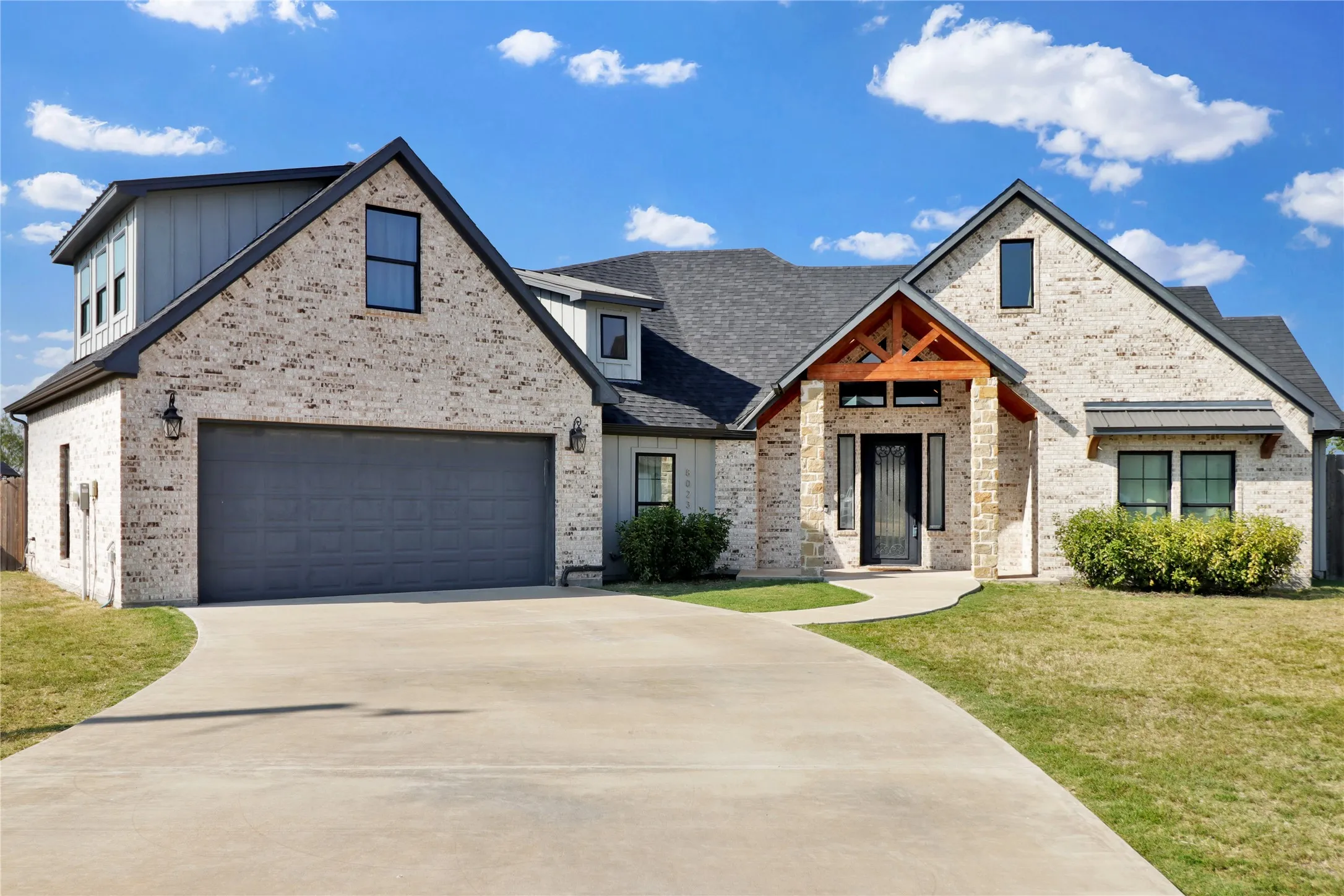 Sidewalk from driveway to front porch.