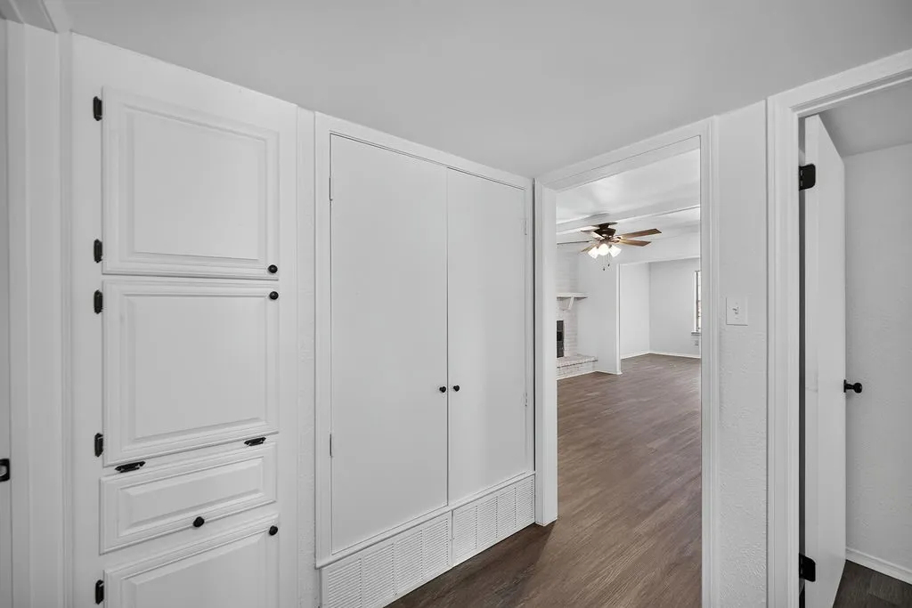 Built-in storage cabinetry with dark hardware