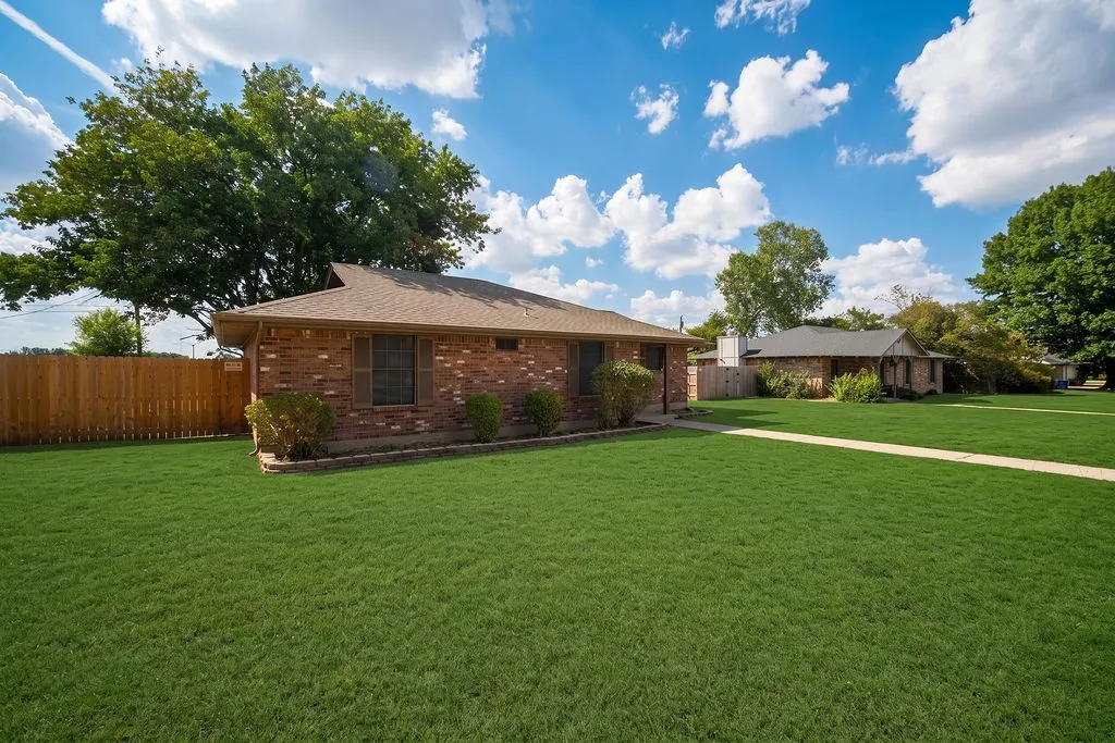 Brick exterior with a gabled roof and brown shutters