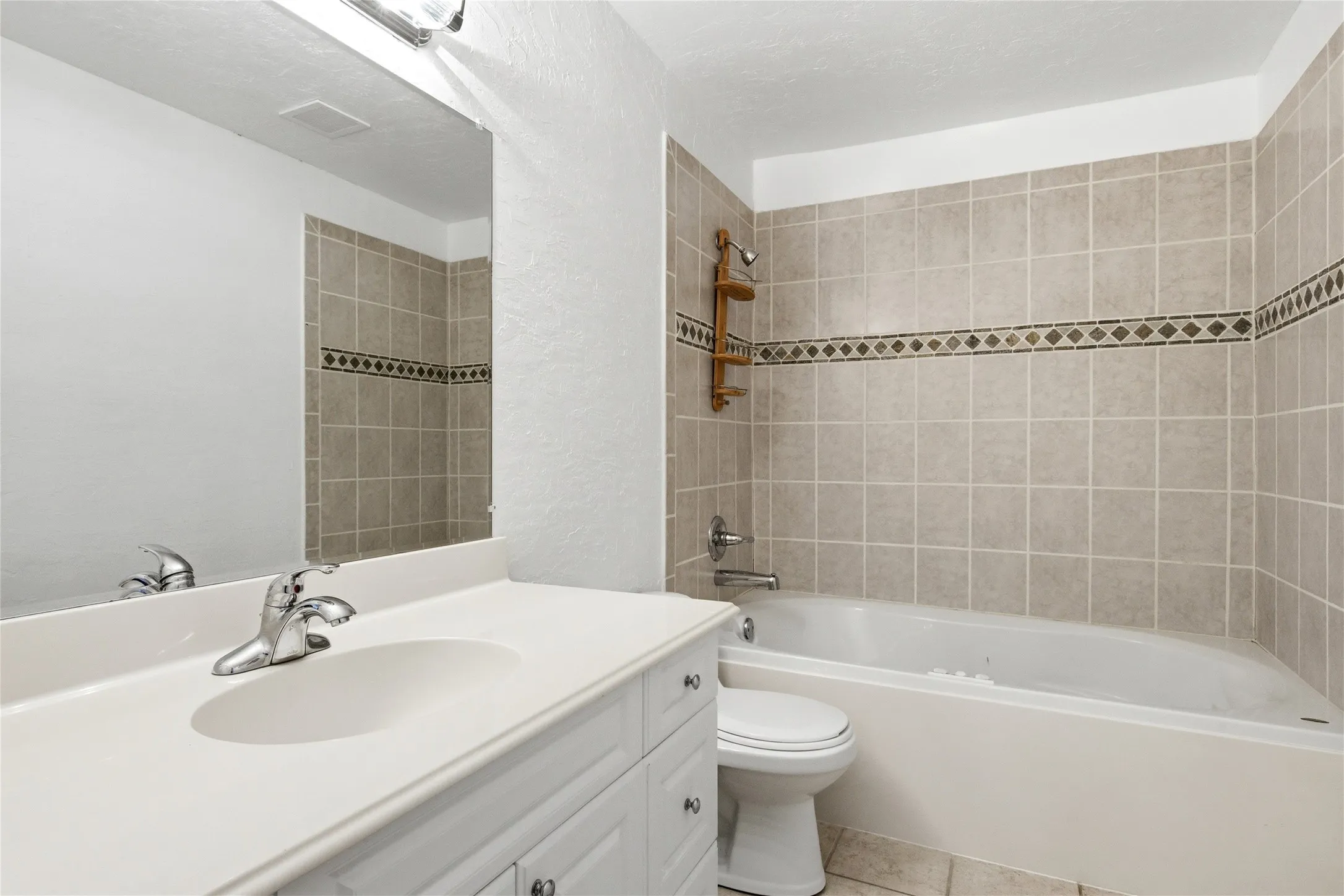 Built-in vanity with integrated sink, chrome faucet, and storage cabinetry