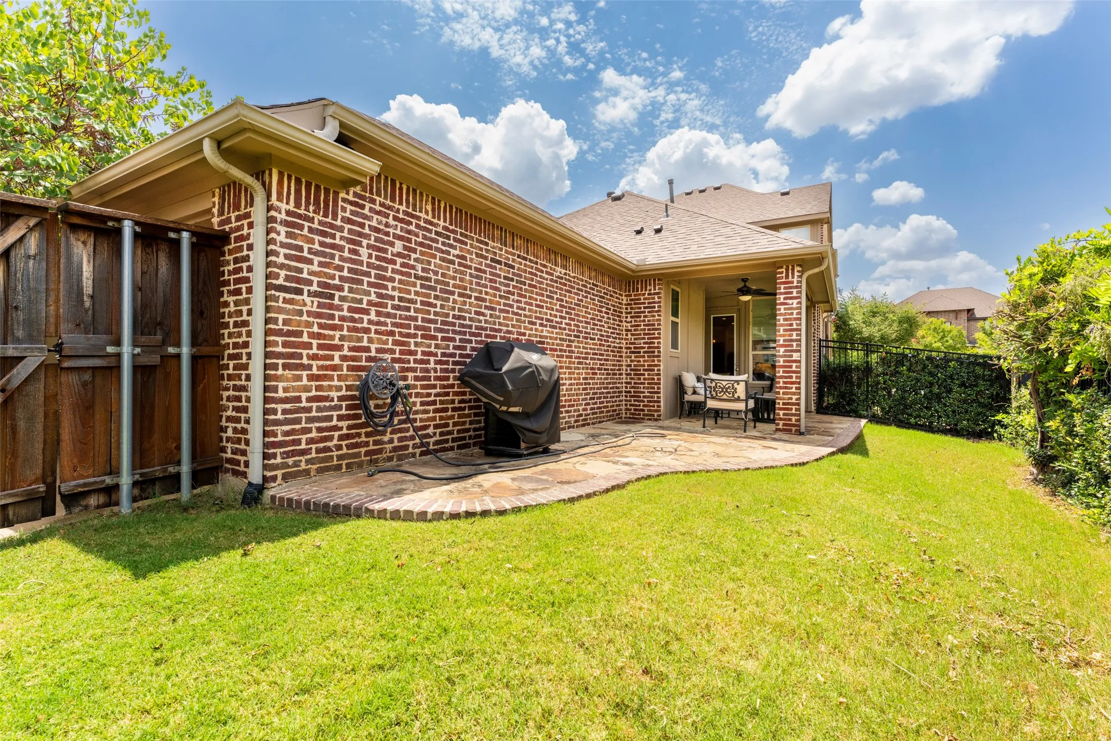Low-Maintenance Backyard: Enjoy a low-maintenance backyard with grassy space for pets, an extended flagstone patio for outdoor entertaining, and easy access to the rear-entry garage. A practical outdoor space offering room to relax, grill, play, and enjoy everyday living.
