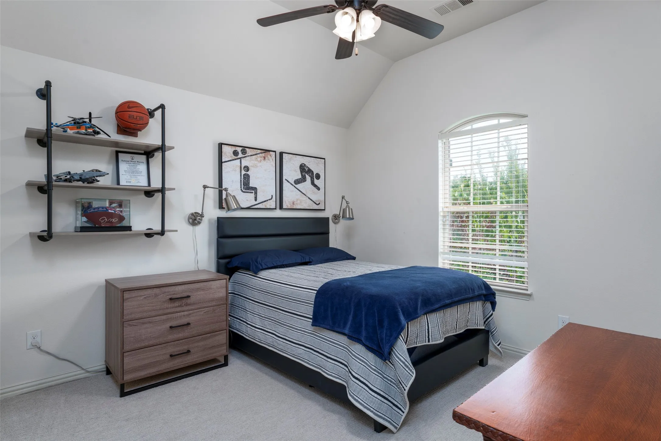 Upstairs Bedroom: Spacious upstairs bedroom offers privacy with a split-bedroom layout, high ceilings, and a ceiling fan for added comfort. Neutral carpeting creates a versatile backdrop, while a large window fills the room with natural light. A generously sized closet provides excellent storage and everyday functionality.