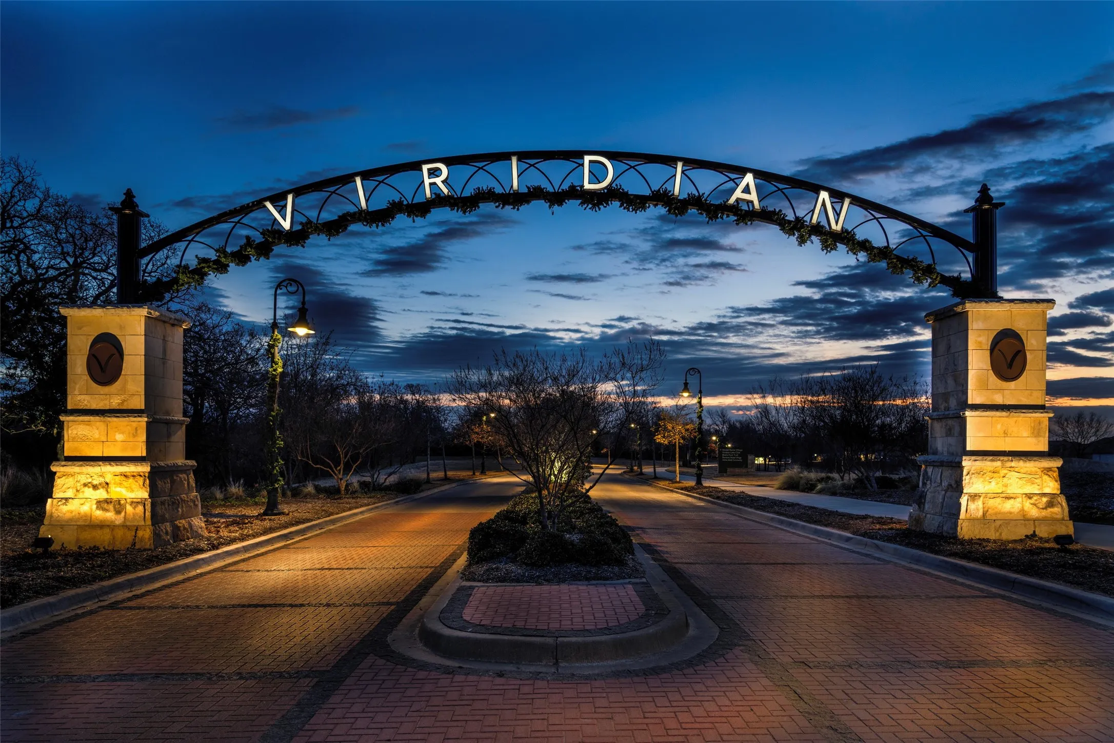 Viridian community entrance at night showcases the neighborhood’s welcoming sense of community, beautifully landscaped common spaces, pedestrian-friendly streets, and inviting gathering areas. This master-planned community offers an exceptional lifestyle with abundant parks, trails, green spaces, and shared amenities designed for connection, recreation, and everyday enjoyment.