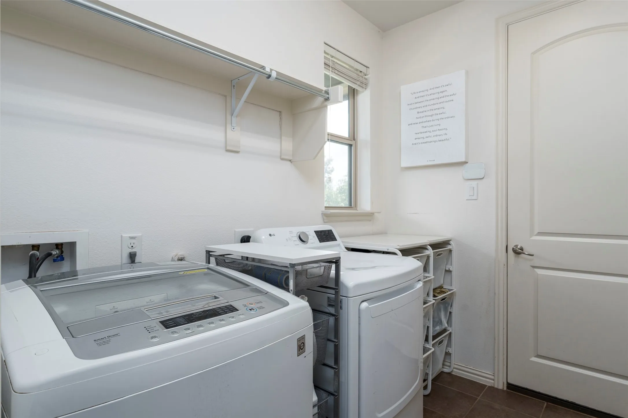 Spacious Utility Room: Dedicated utility room offers excellent functionality with a convenient hanging rod, folding space, and room for full-size washer and dryer. Open floor space provides flexibility to add additional storage, shelving, or organization solutions. A window brings in natural light.