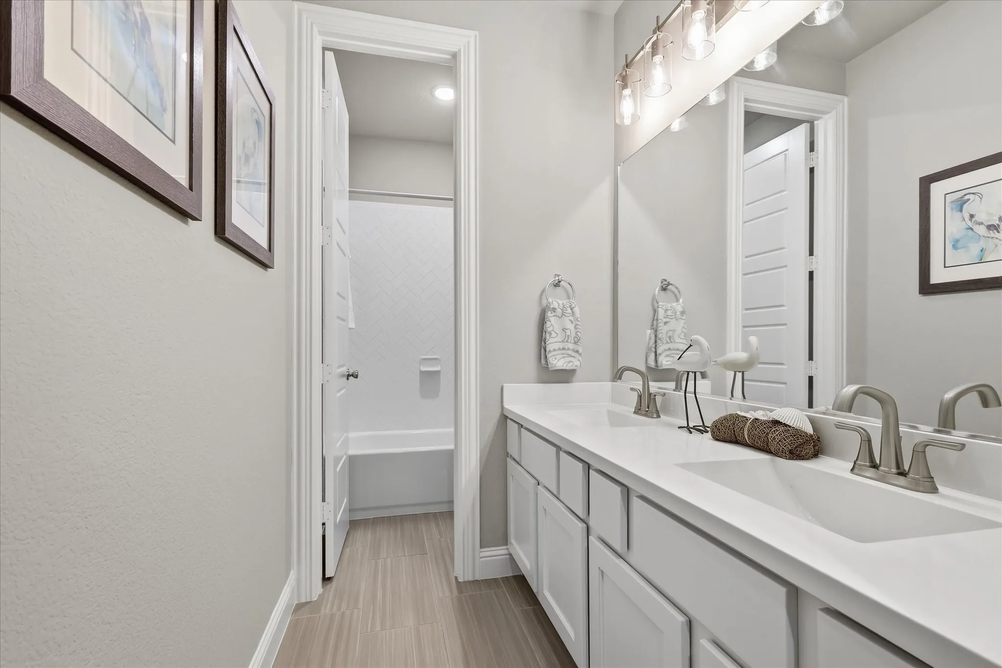 Dual sink vanity with white countertops and brushed nickel fixtures
