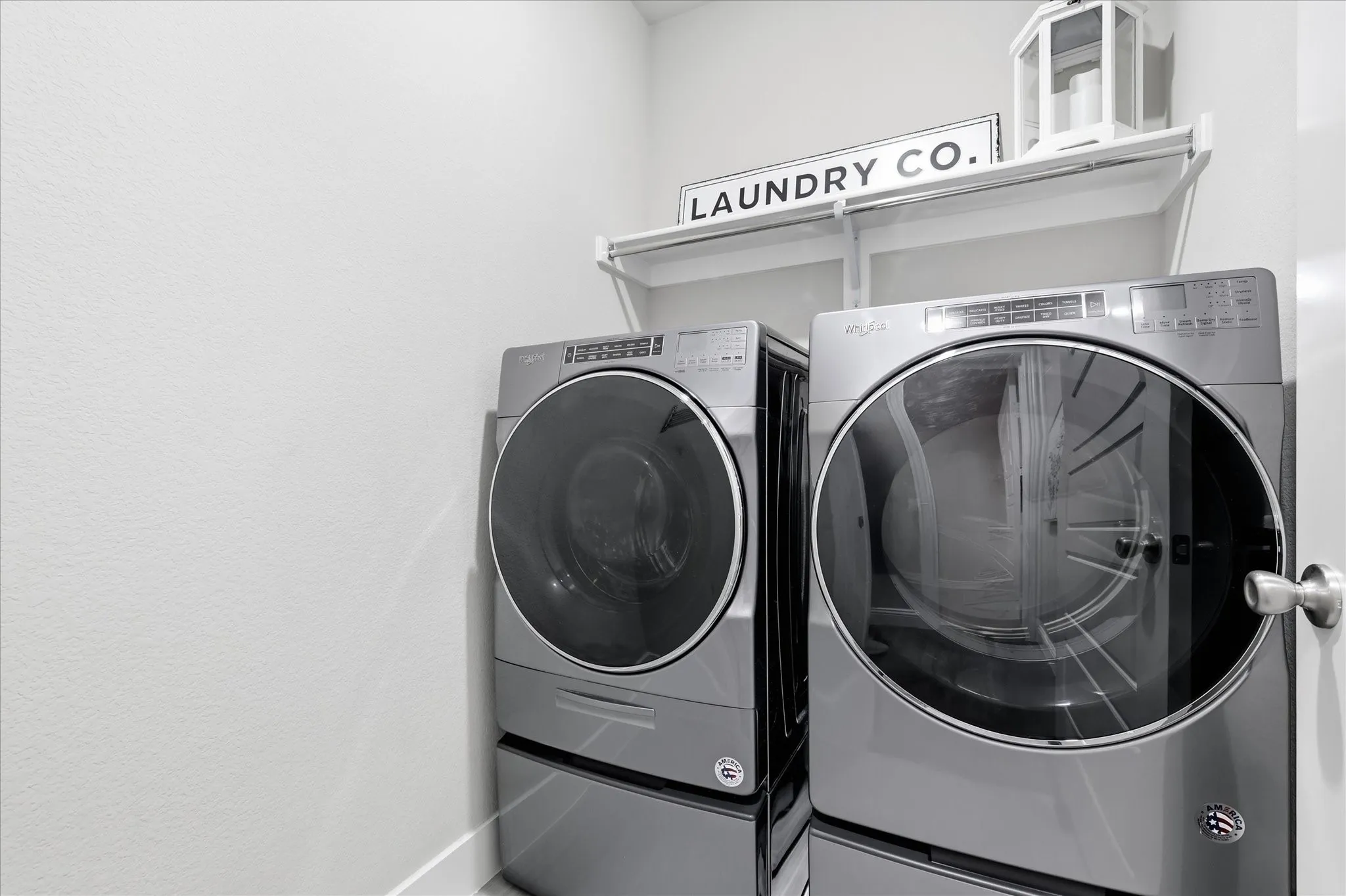 Dedicated laundry area featuring a wall-mounted shelf