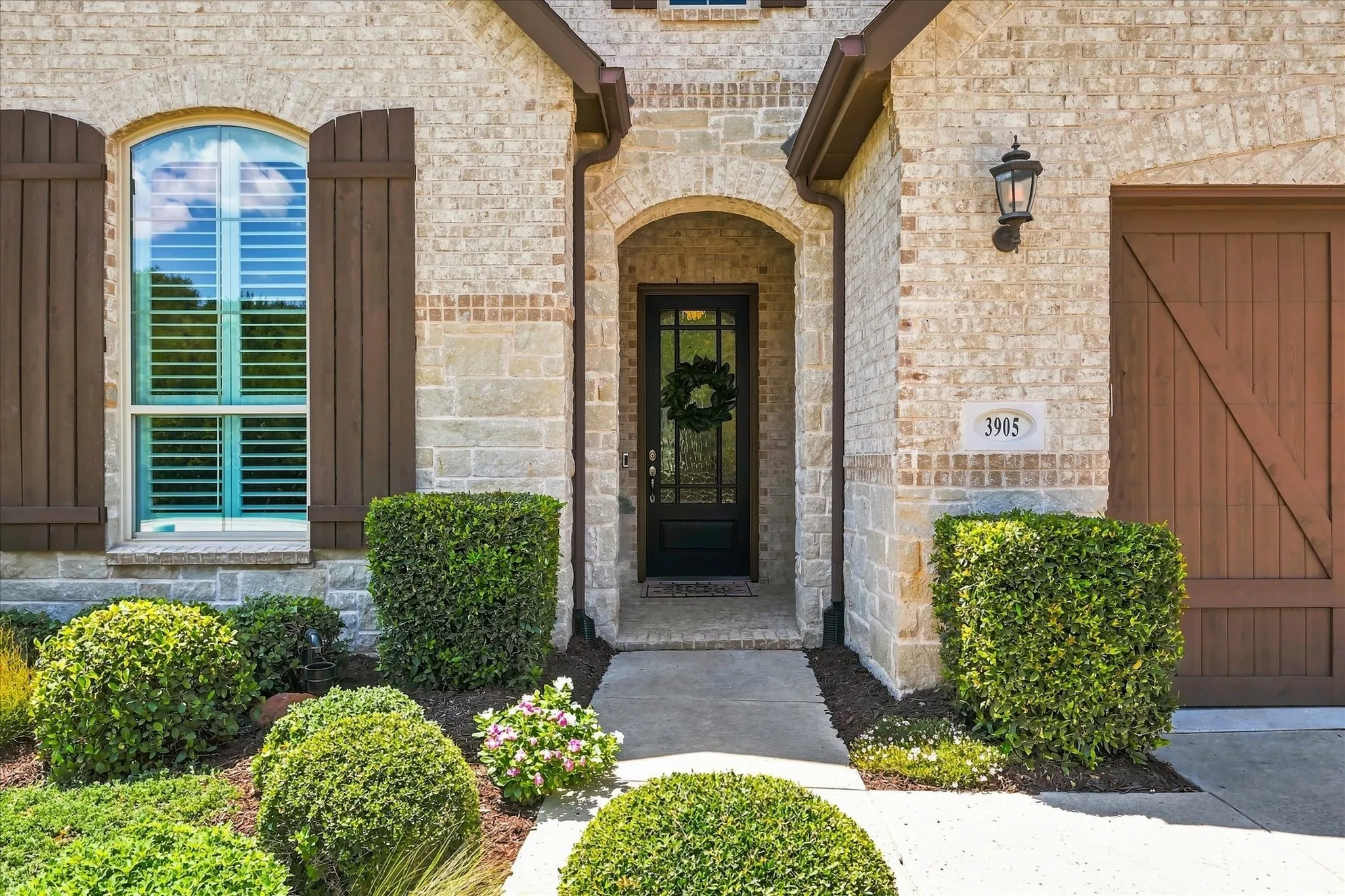 Brick and stone exterior with an arched entry