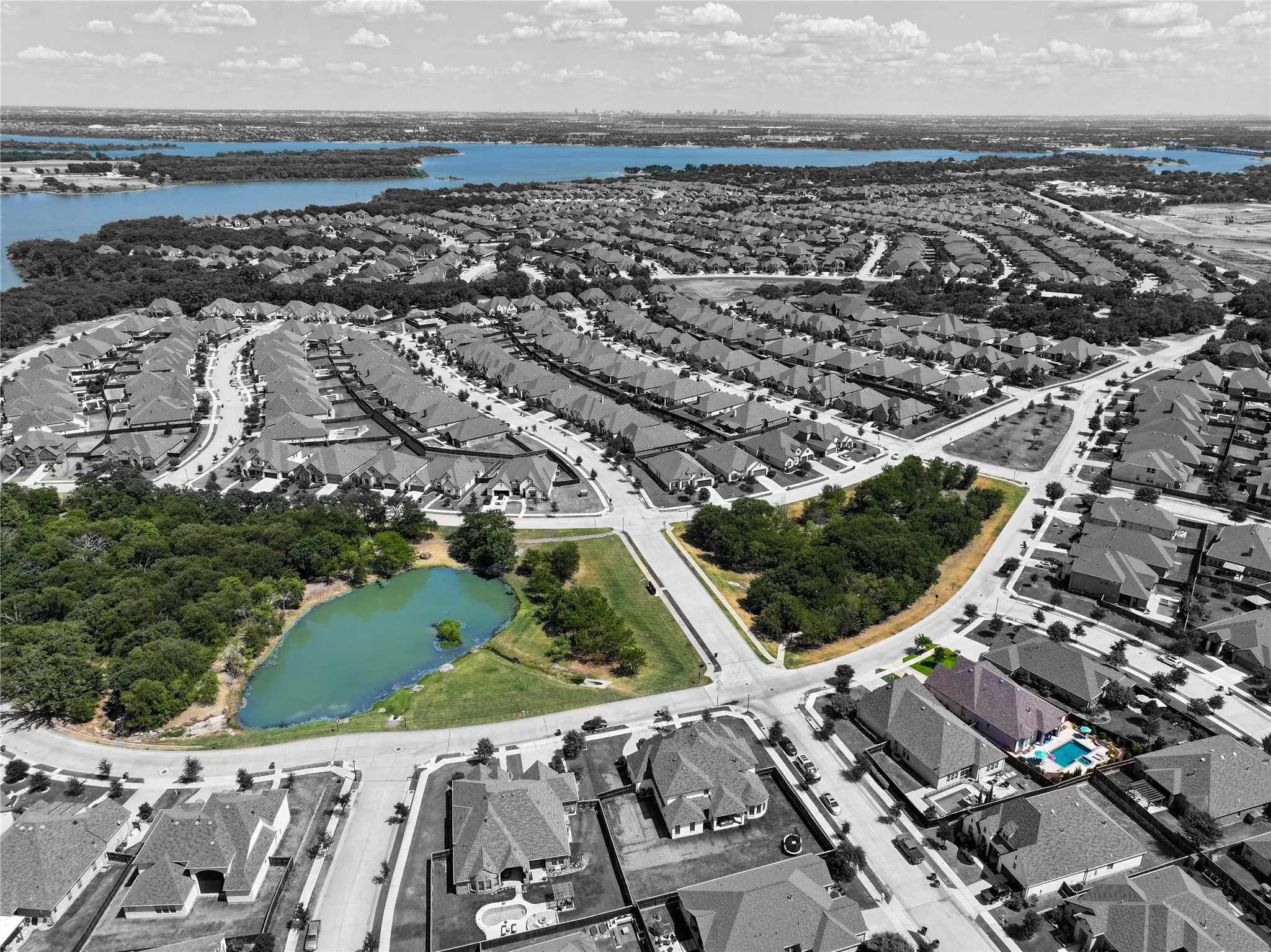 Aerial perspective showcasing a residential community with a large body of water in the background