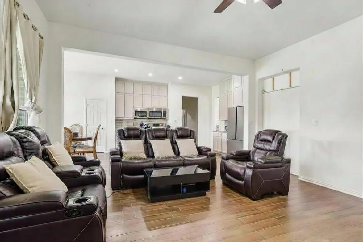 Wood-look ceramic tile flooring throughout, recessed lighting, and a ceiling fan