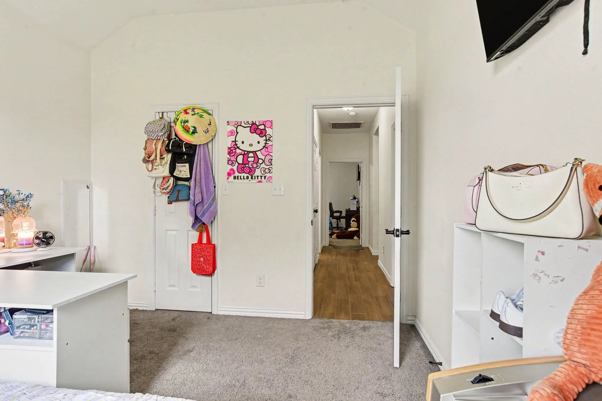 Vaulted ceiling and carpet flooring.