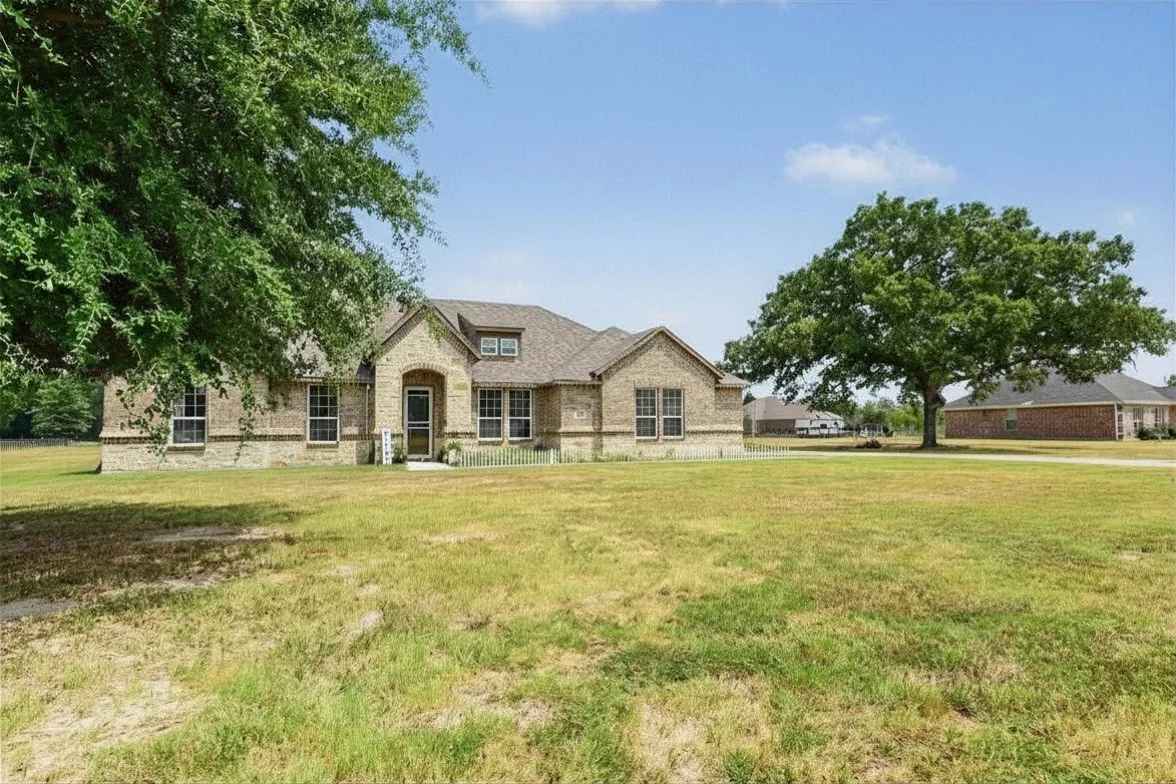 Elegant stone exterior residence set on expansive grounds with mature landscaping