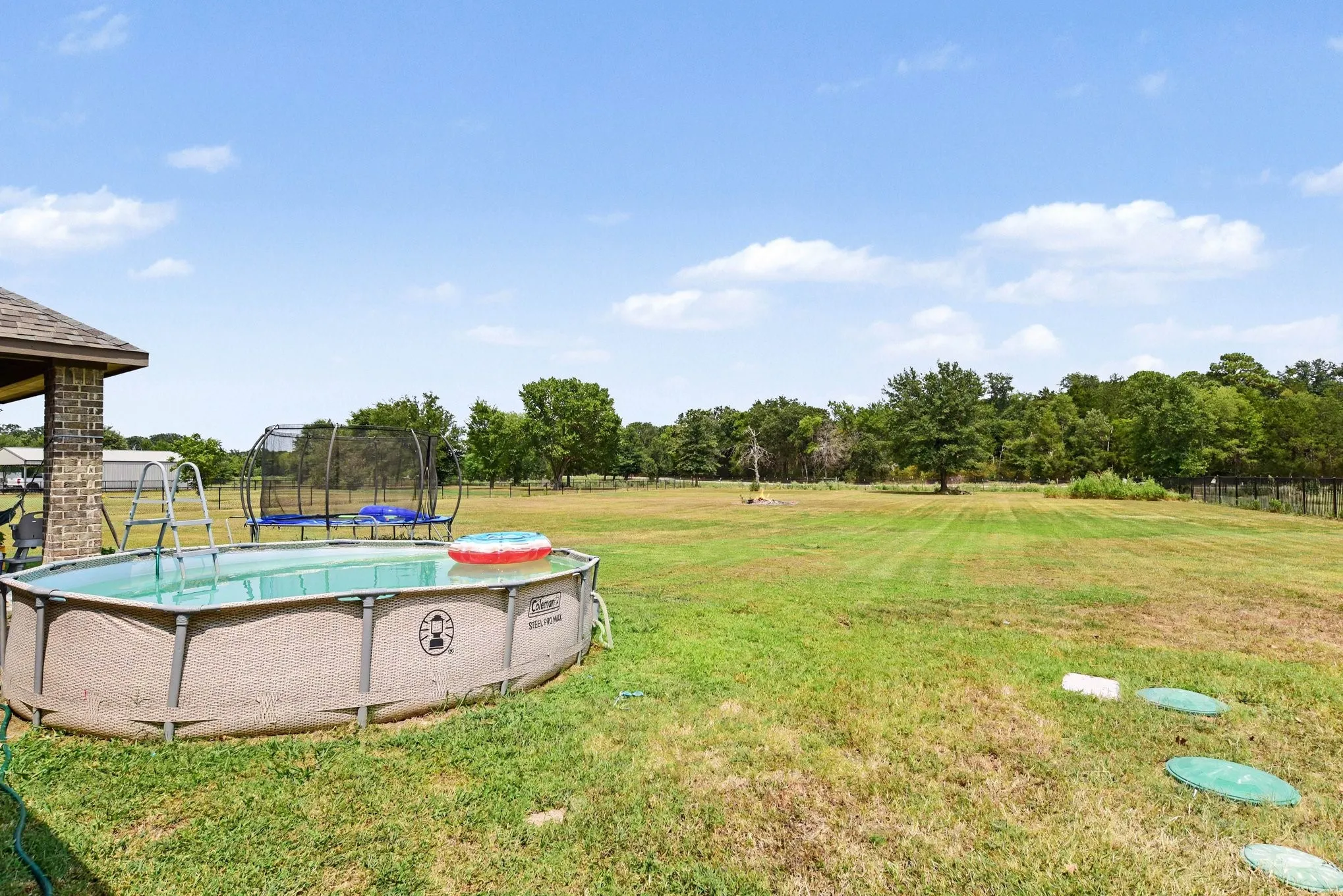 Above ground pool, and yard.
