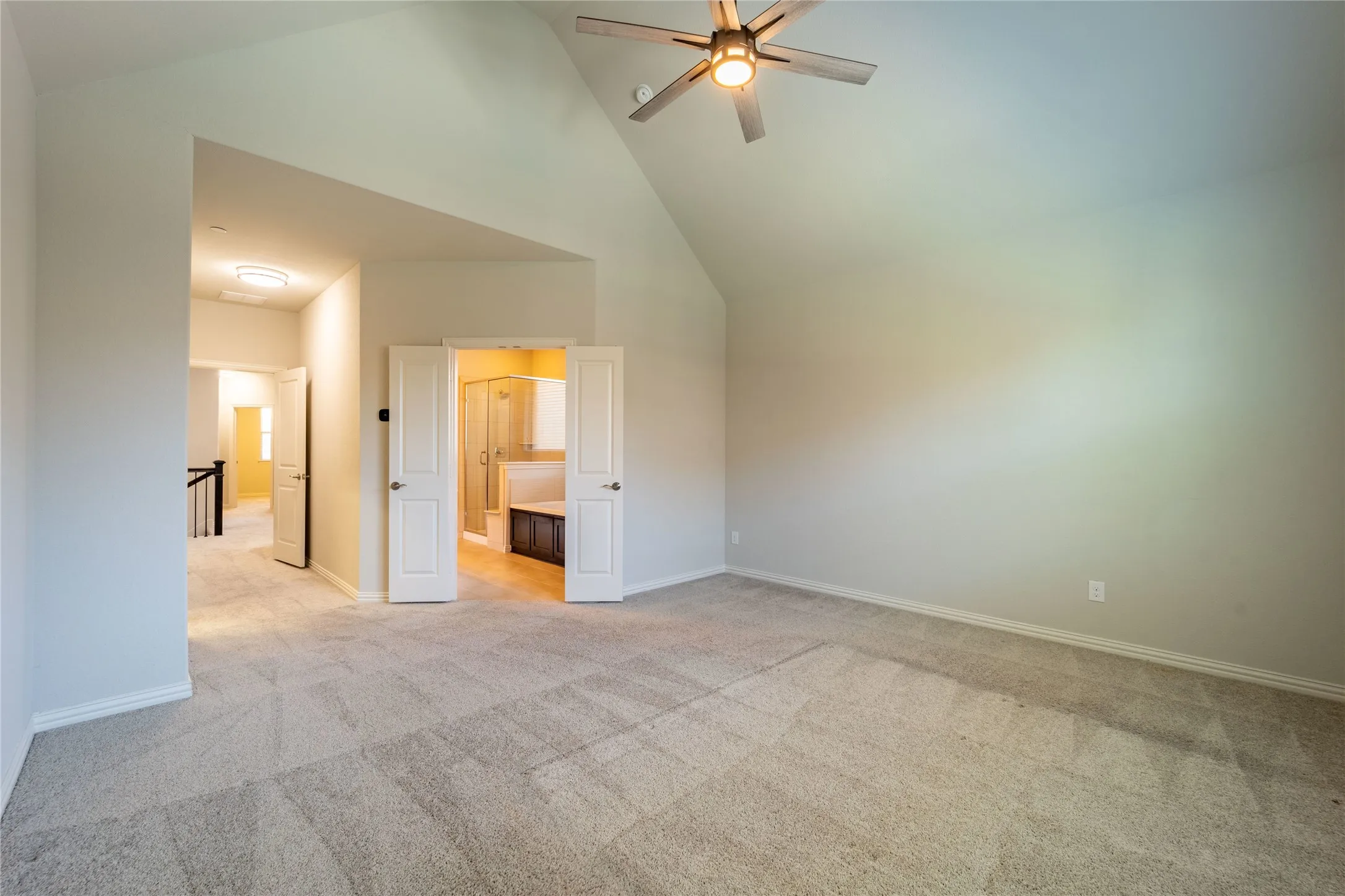 Double doors lead you to the luxurious primary bath