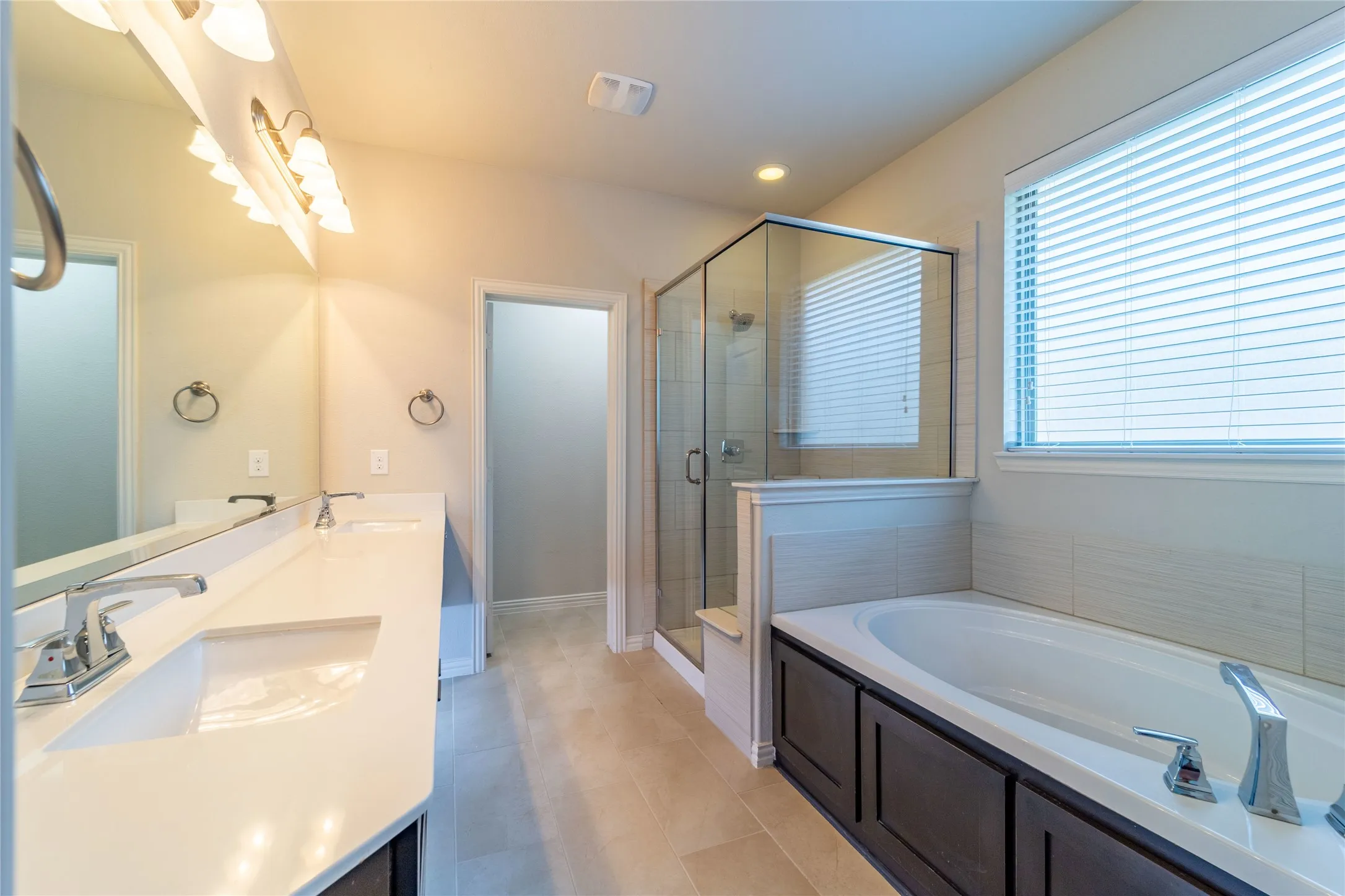 Separate garden tub and roomy shower with seat
