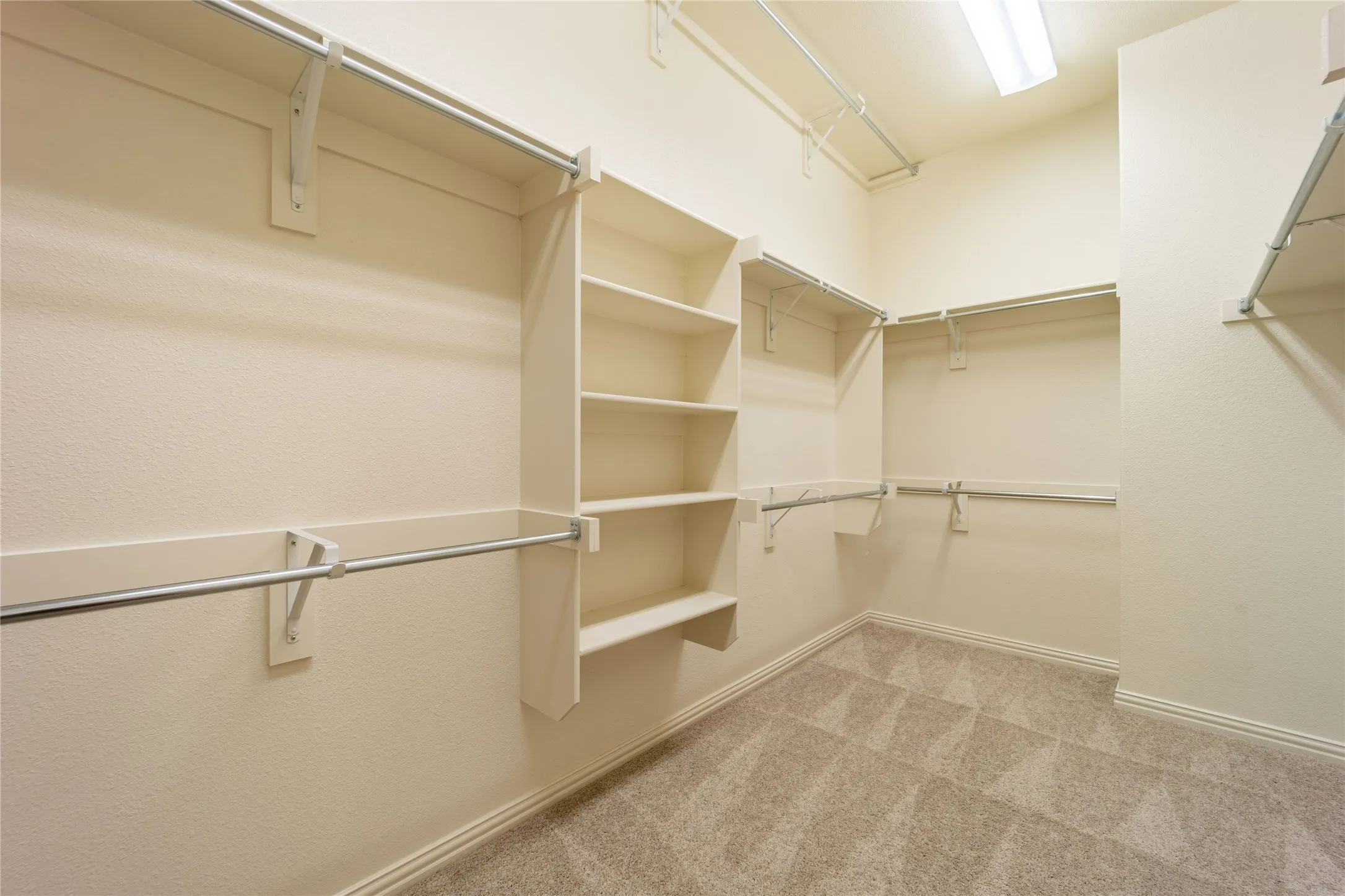 This closet is huge and has 3 rows of hanging space and built-in shelves!