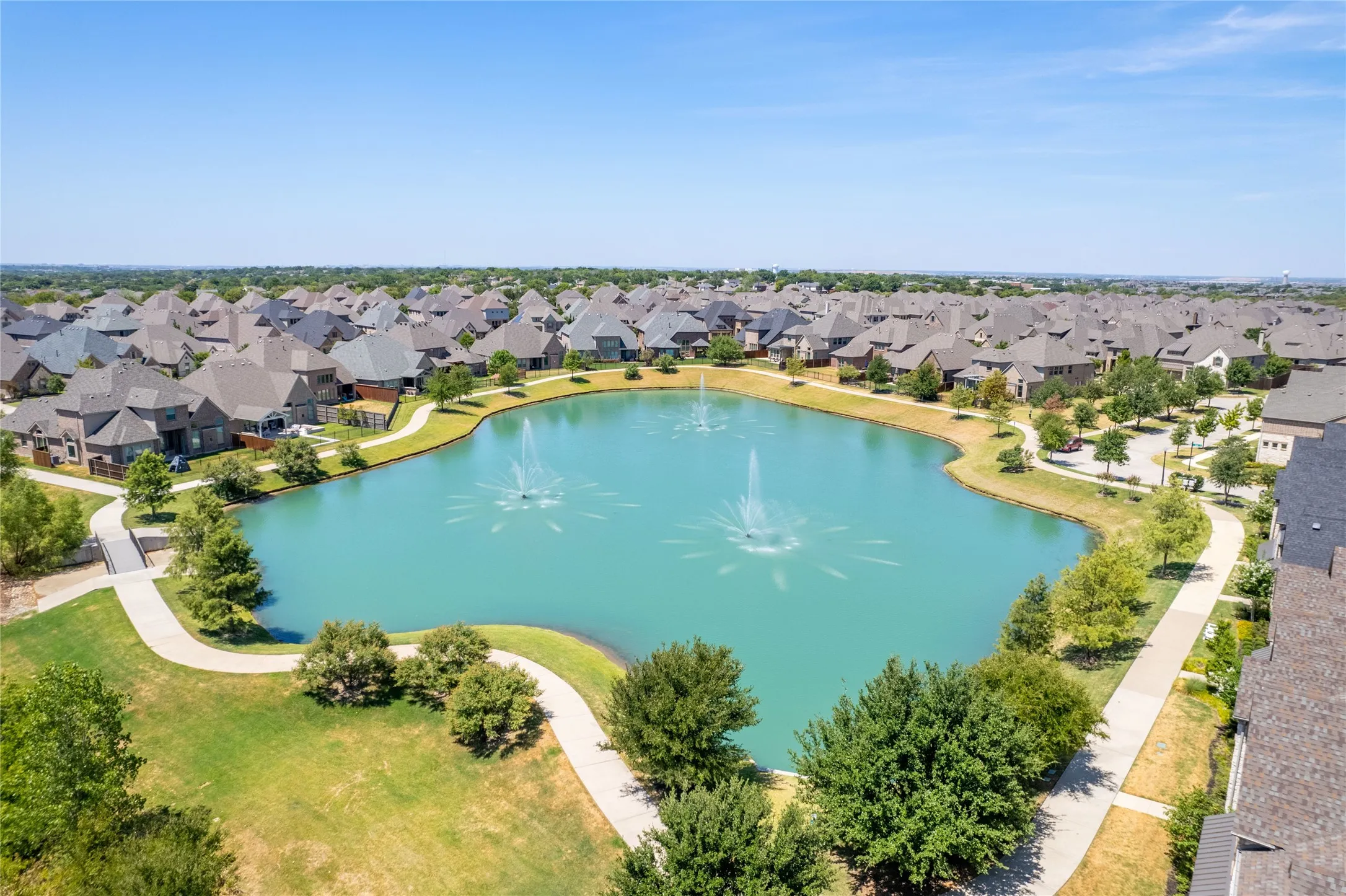Tranquil pond with fountain and trail