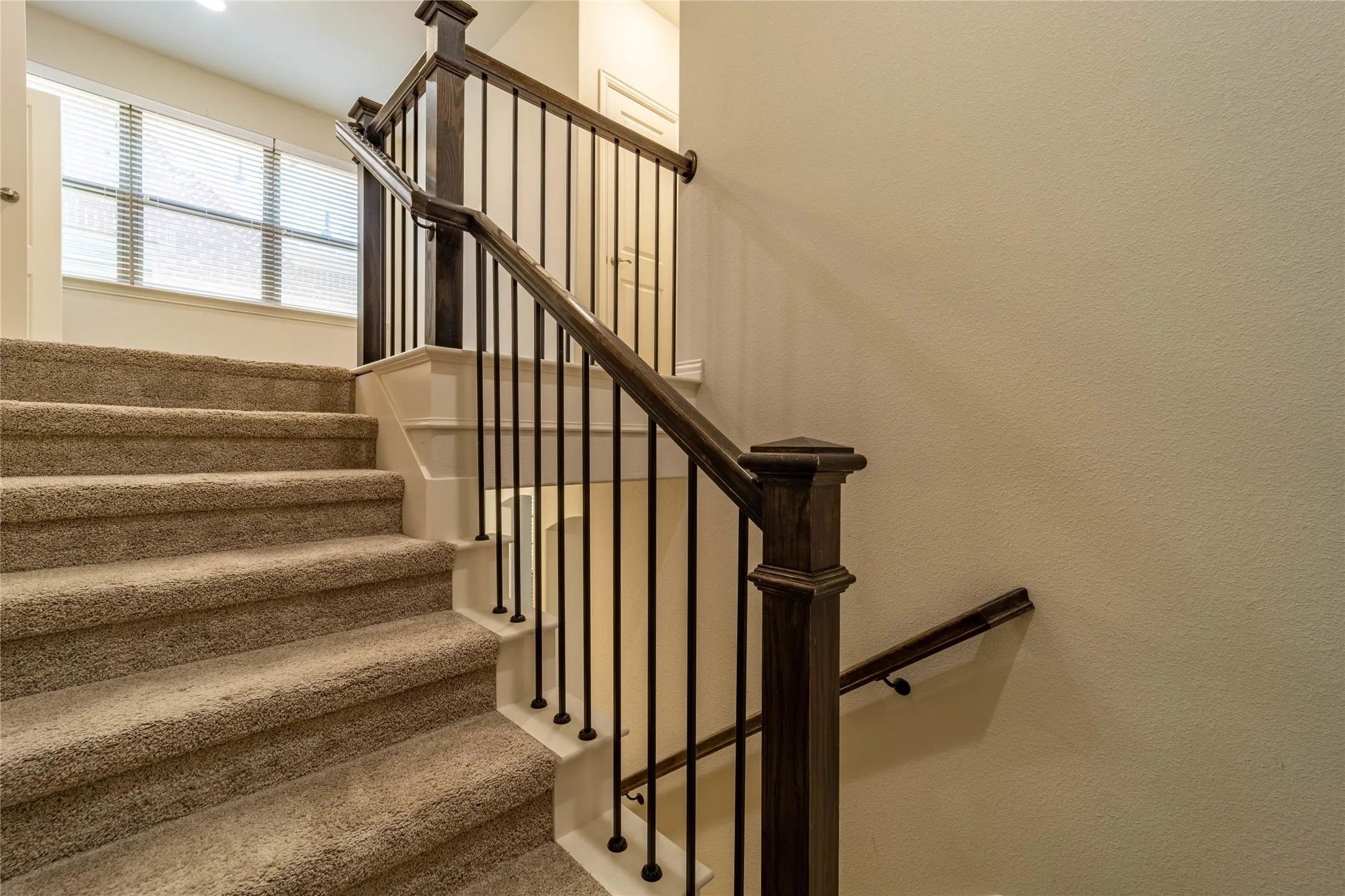 Rich wood and iron stair railing