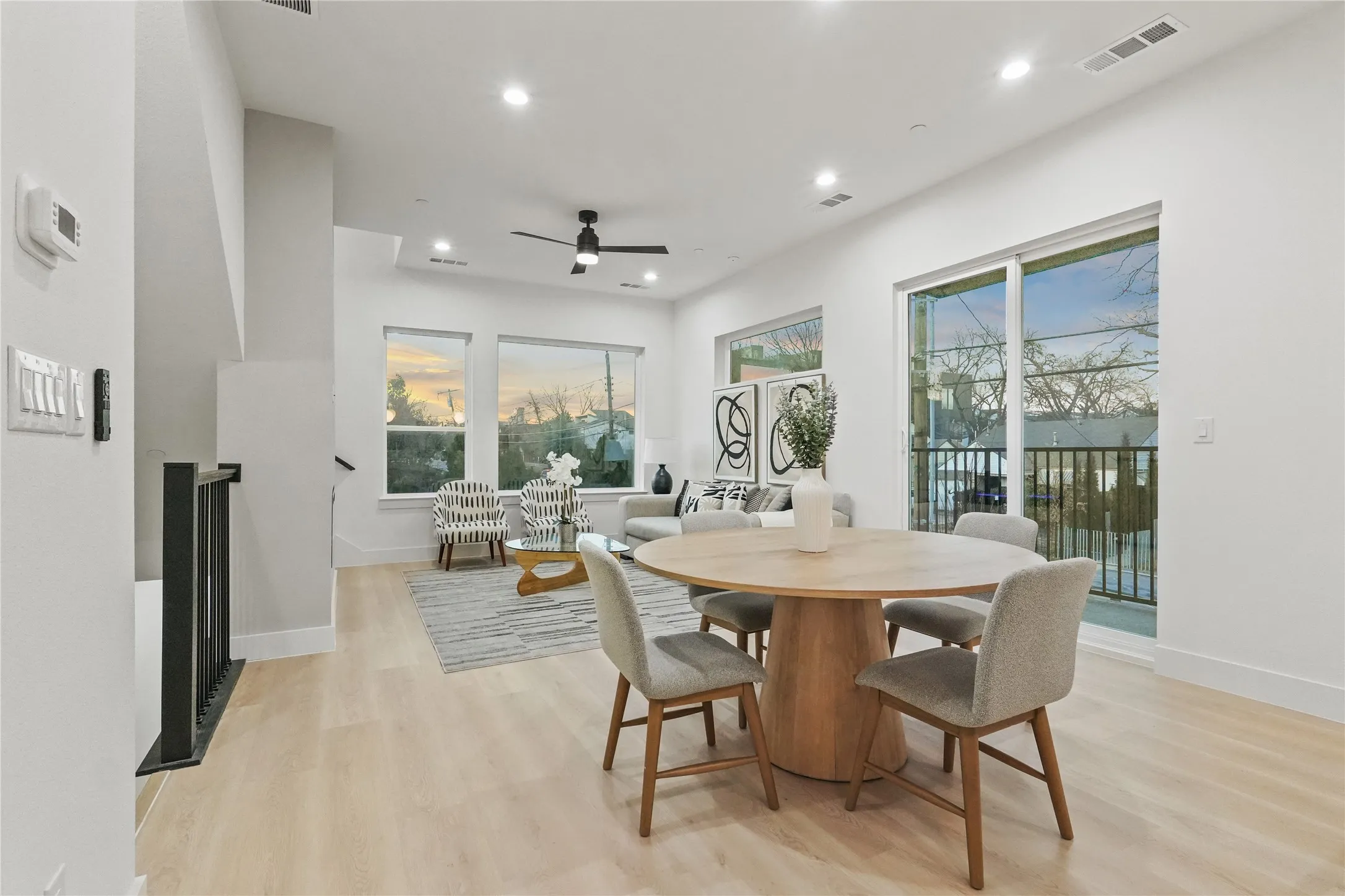Dining space featuring light wood finished floors, ceiling fan, and recessed lighting