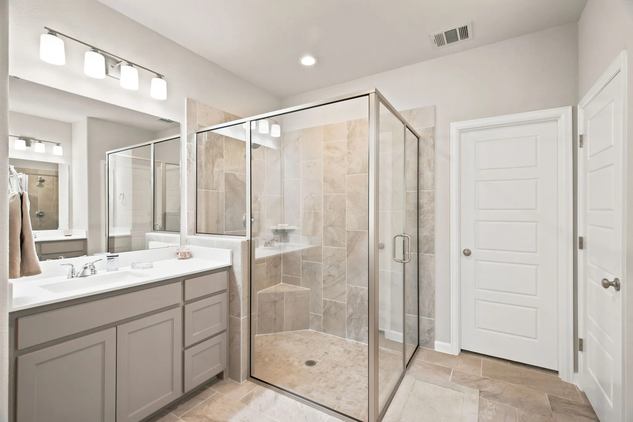 Dual vanity with white countertop, chrome fixtures, and undermount sinks
