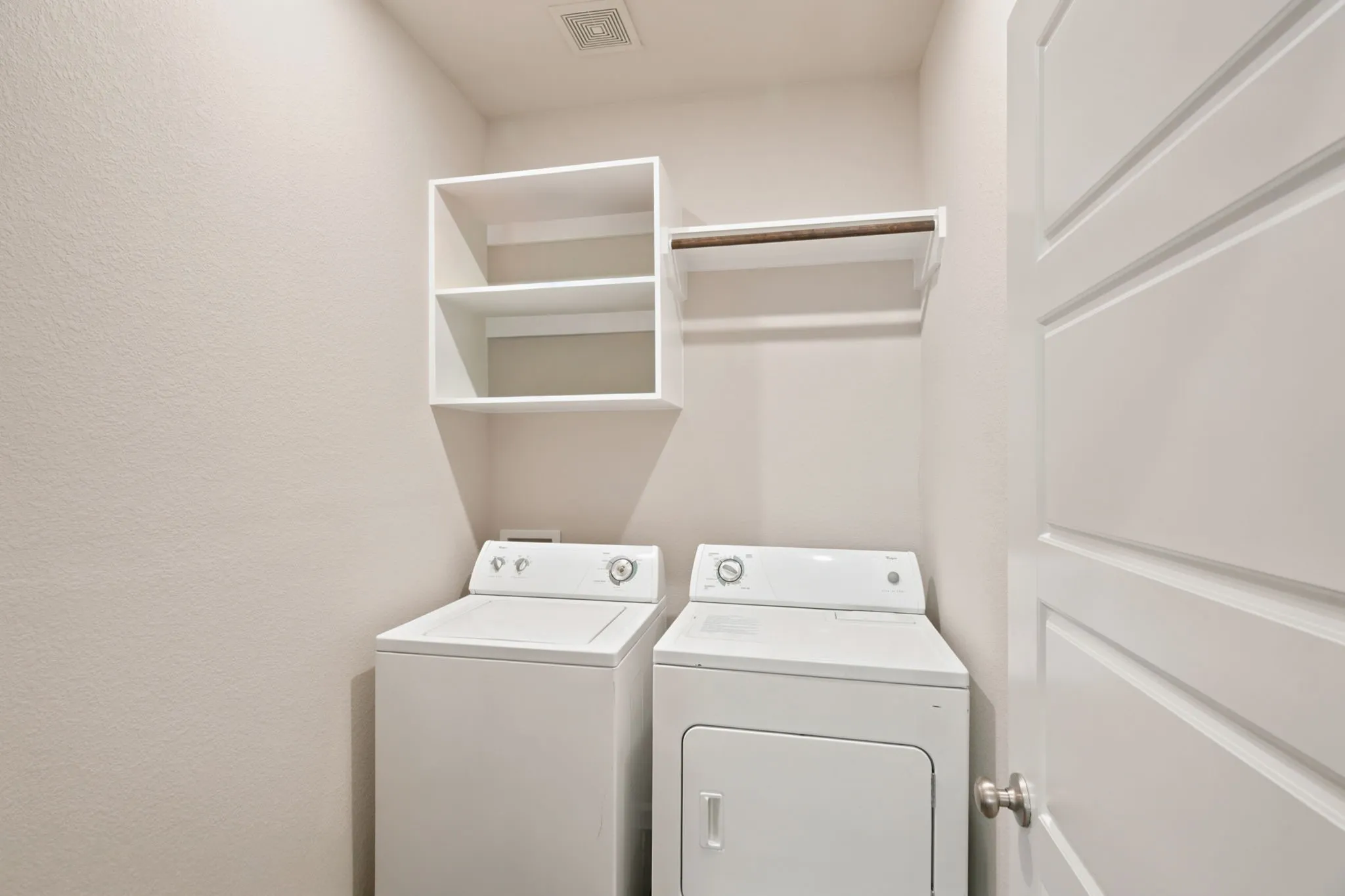 Laundry area with built-in shelving and hanging rod