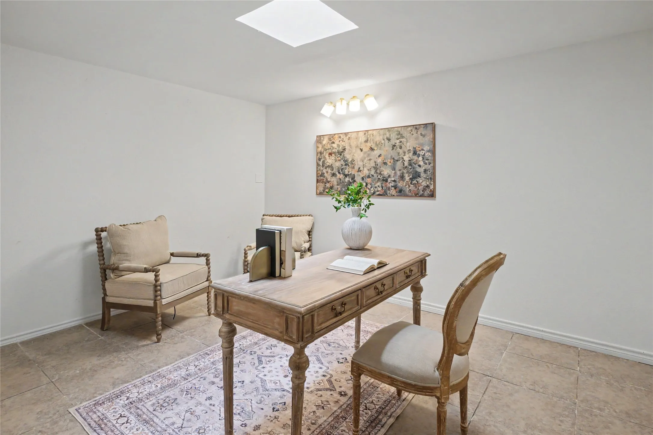 Recessed ceiling light, wall sconce lighting, and square tiled flooring
